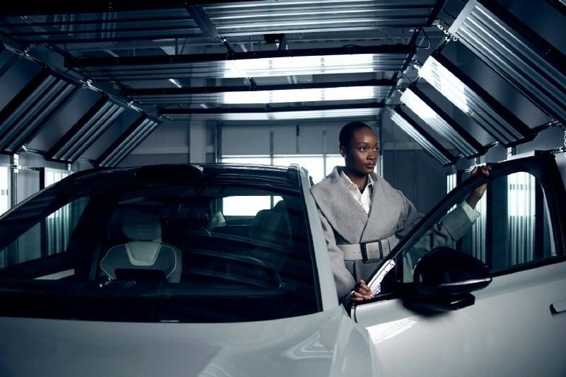 A person standing in a car
AI-generated content may be incorrect.
