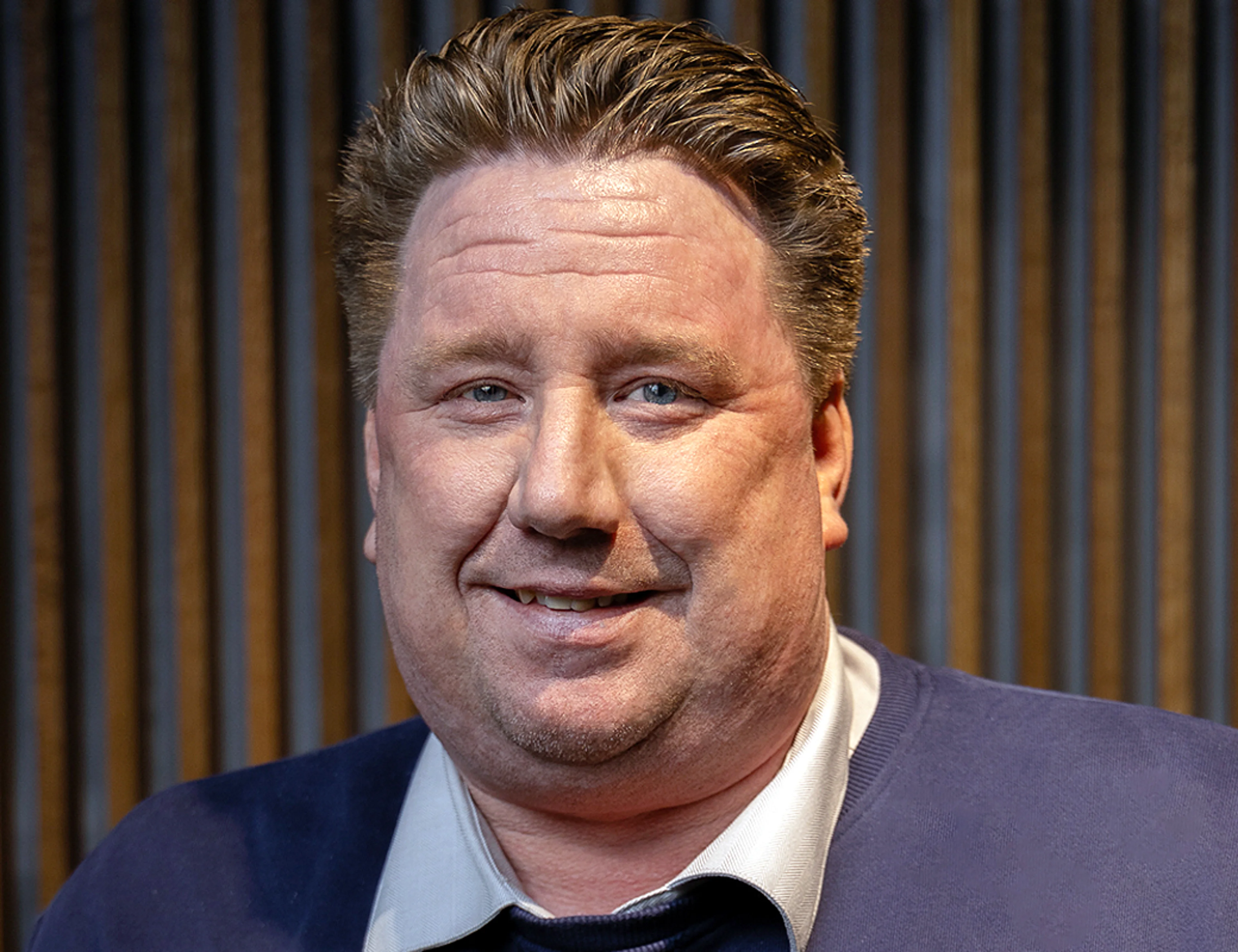 A portrait photo of a man smilling.