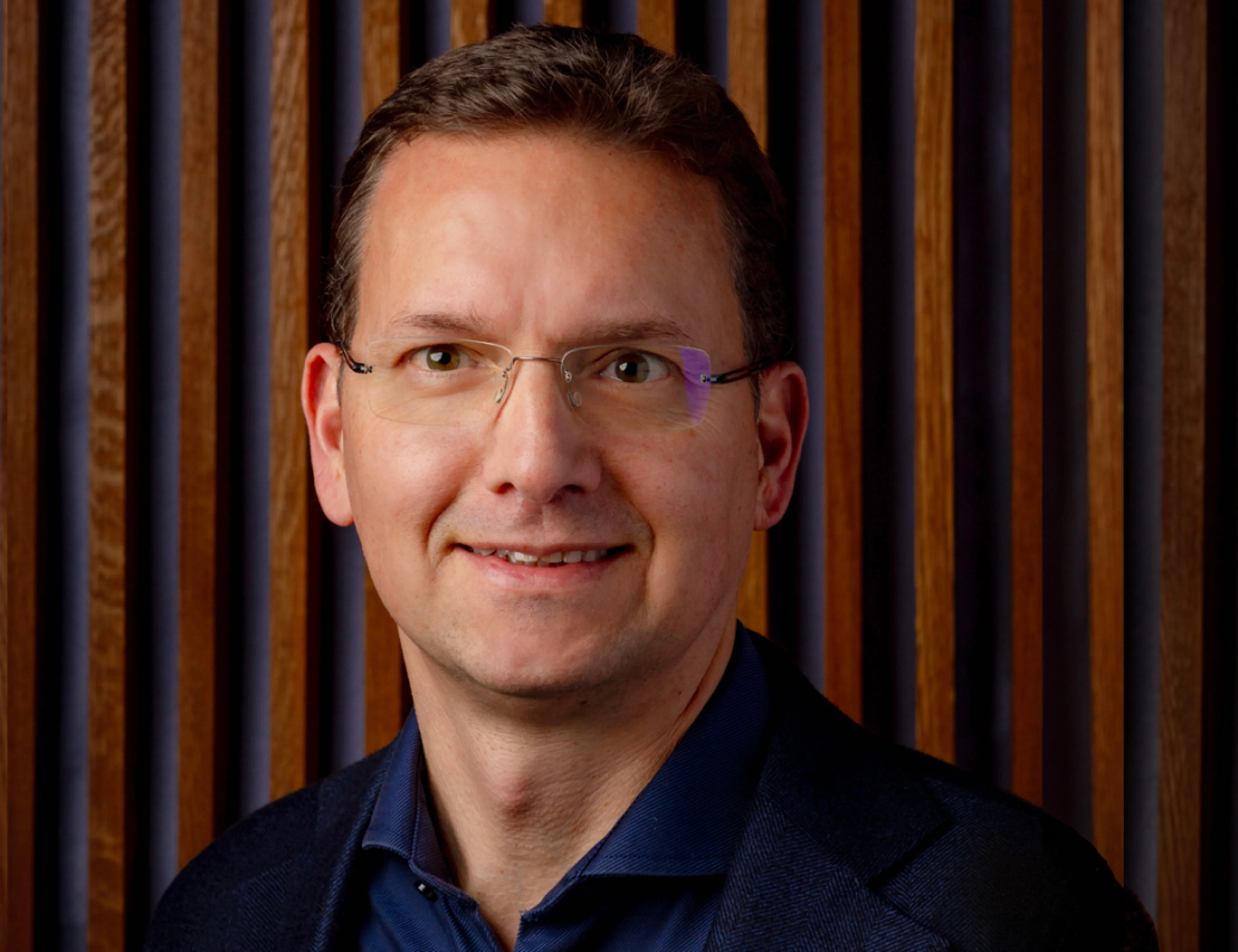 A portrait photo of a man smilling.