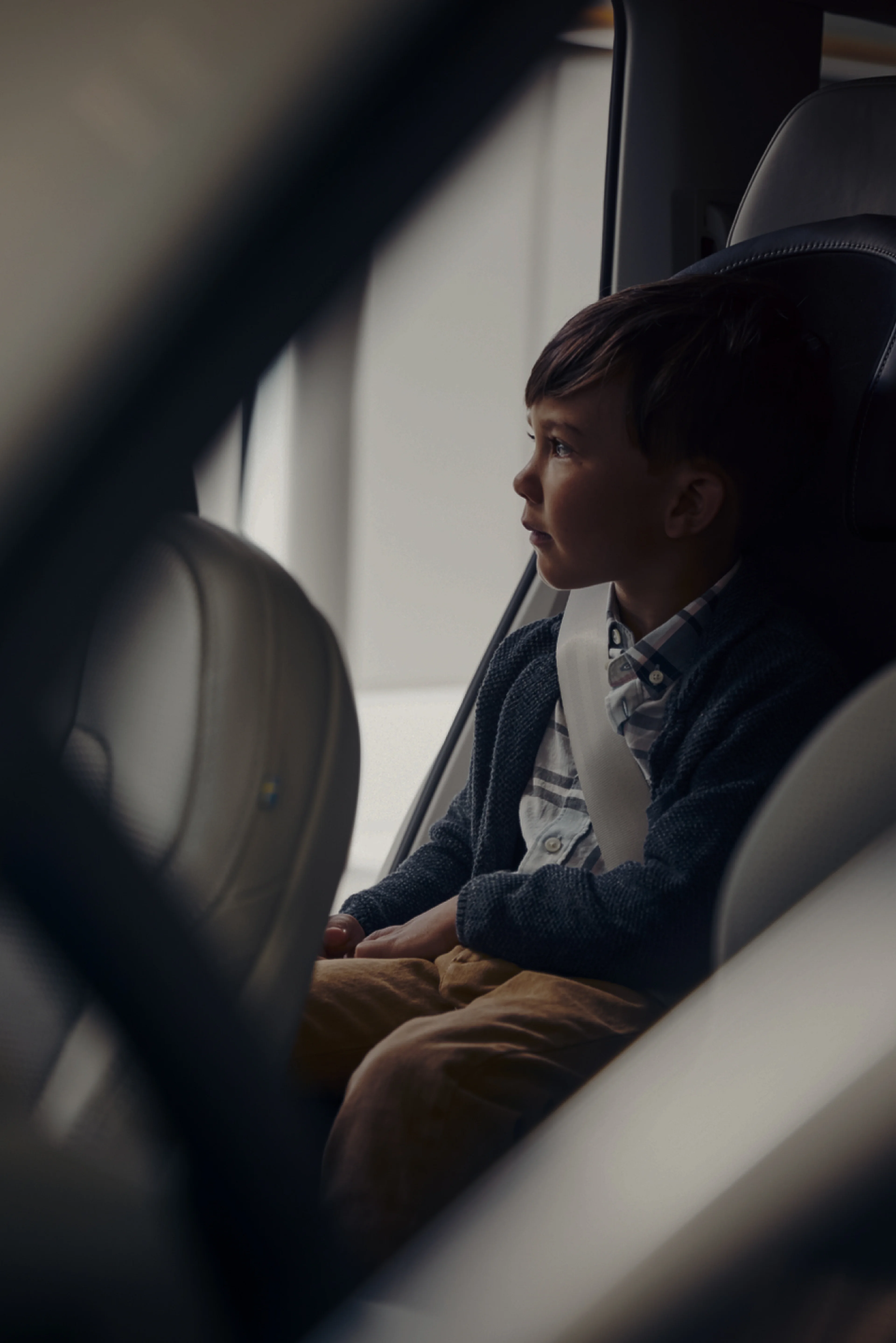 A child sat on child seat looking outside.