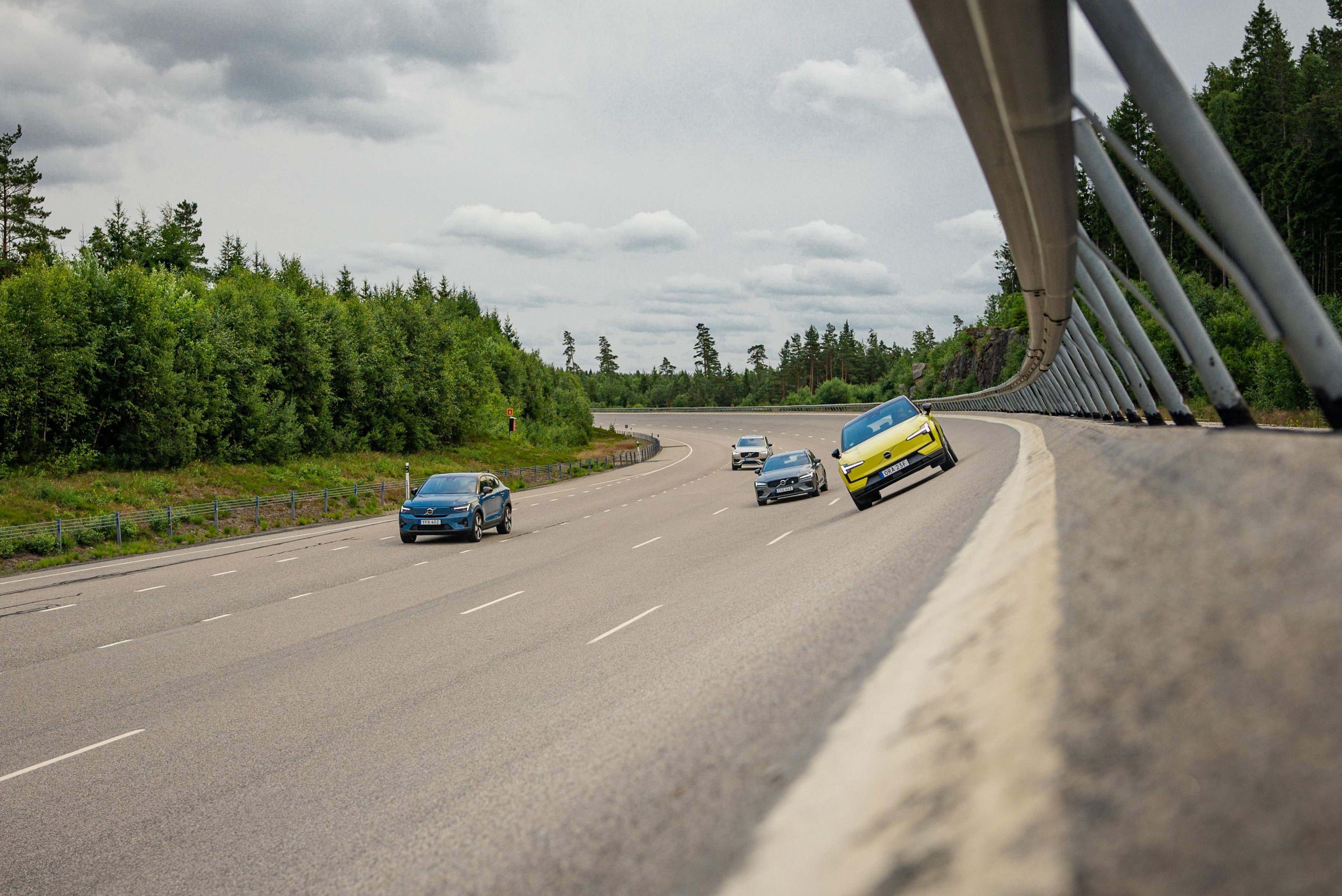 Four Volvo cars driving on the high speed track.