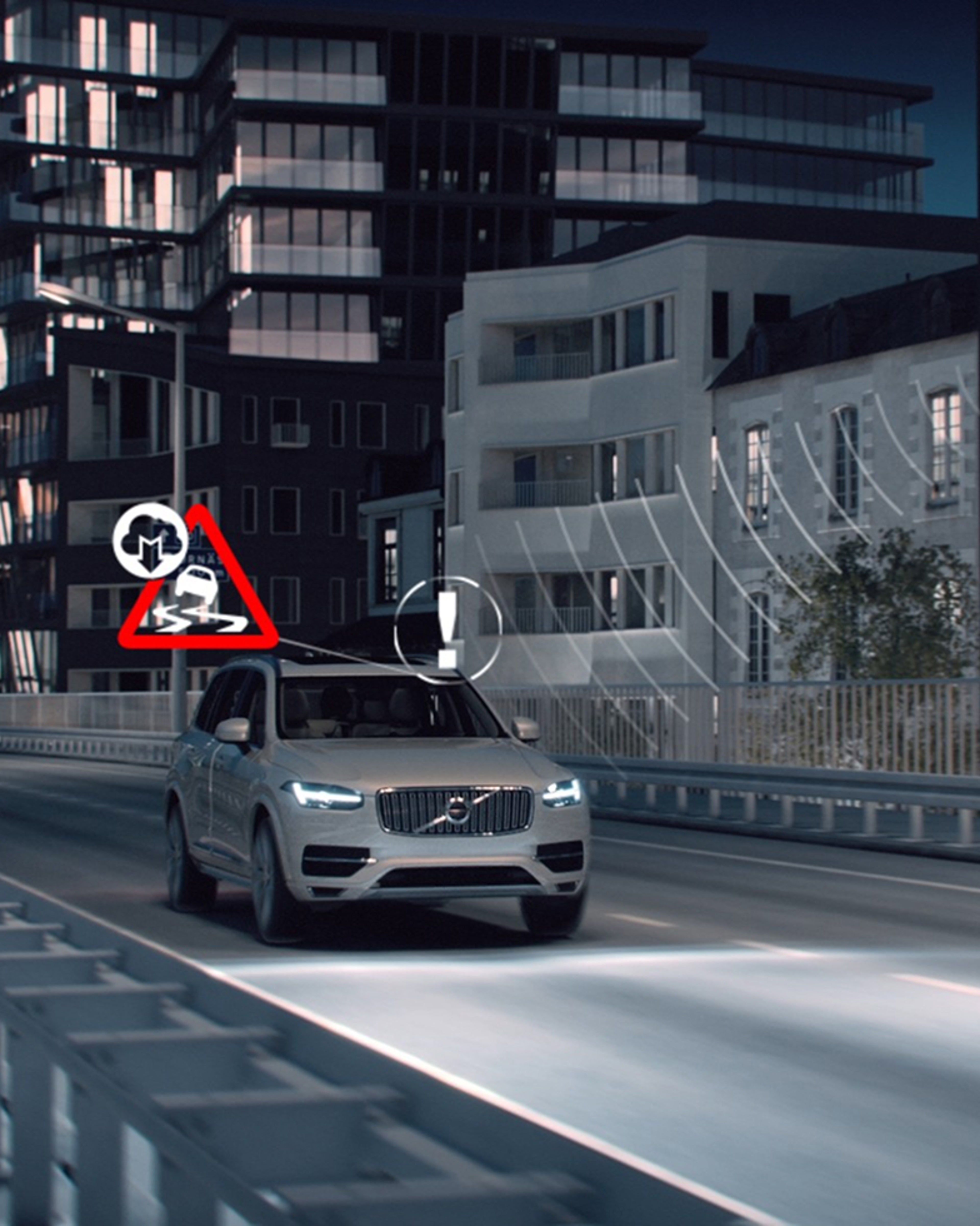 A silver Volvo SUV driving at night on a road with illuminated hazard icons above the car. Tall buildings in the background behind the car.