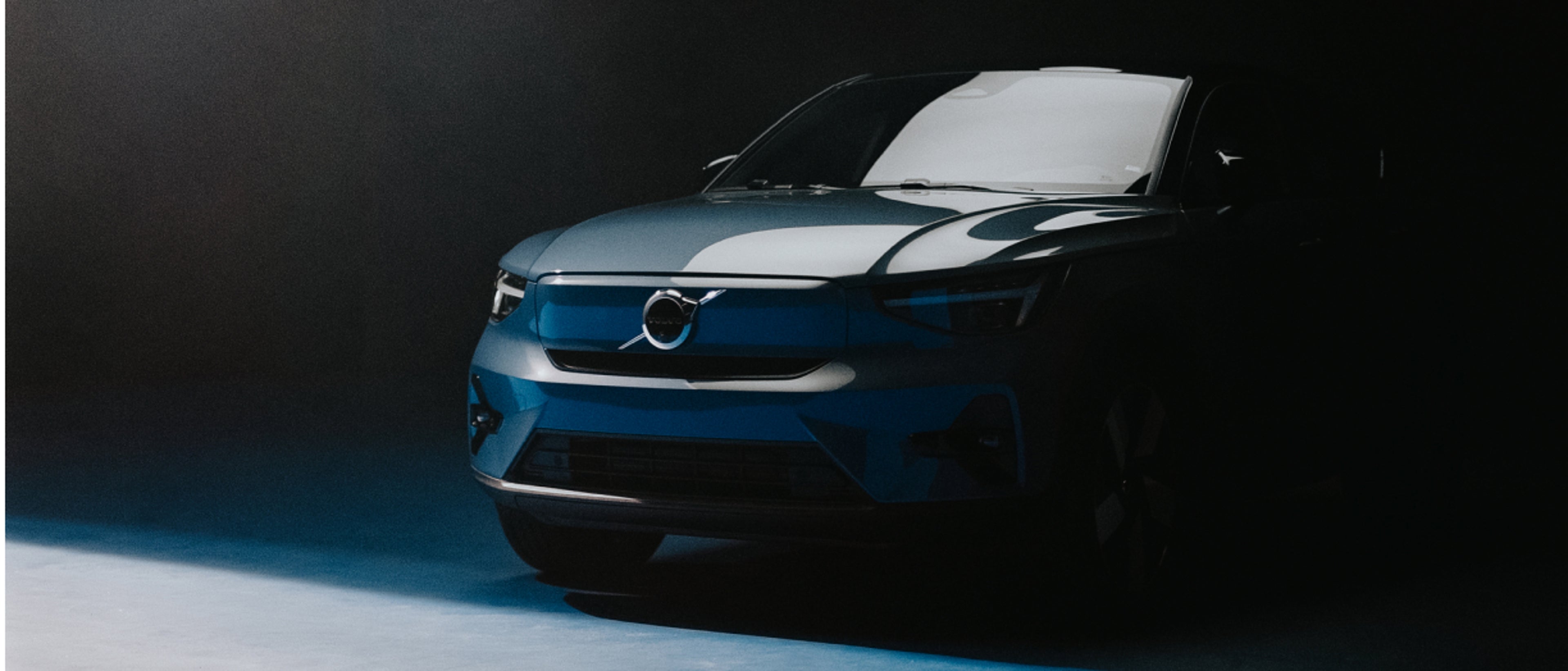 A partial front three-quarters shot of a Volvo car.