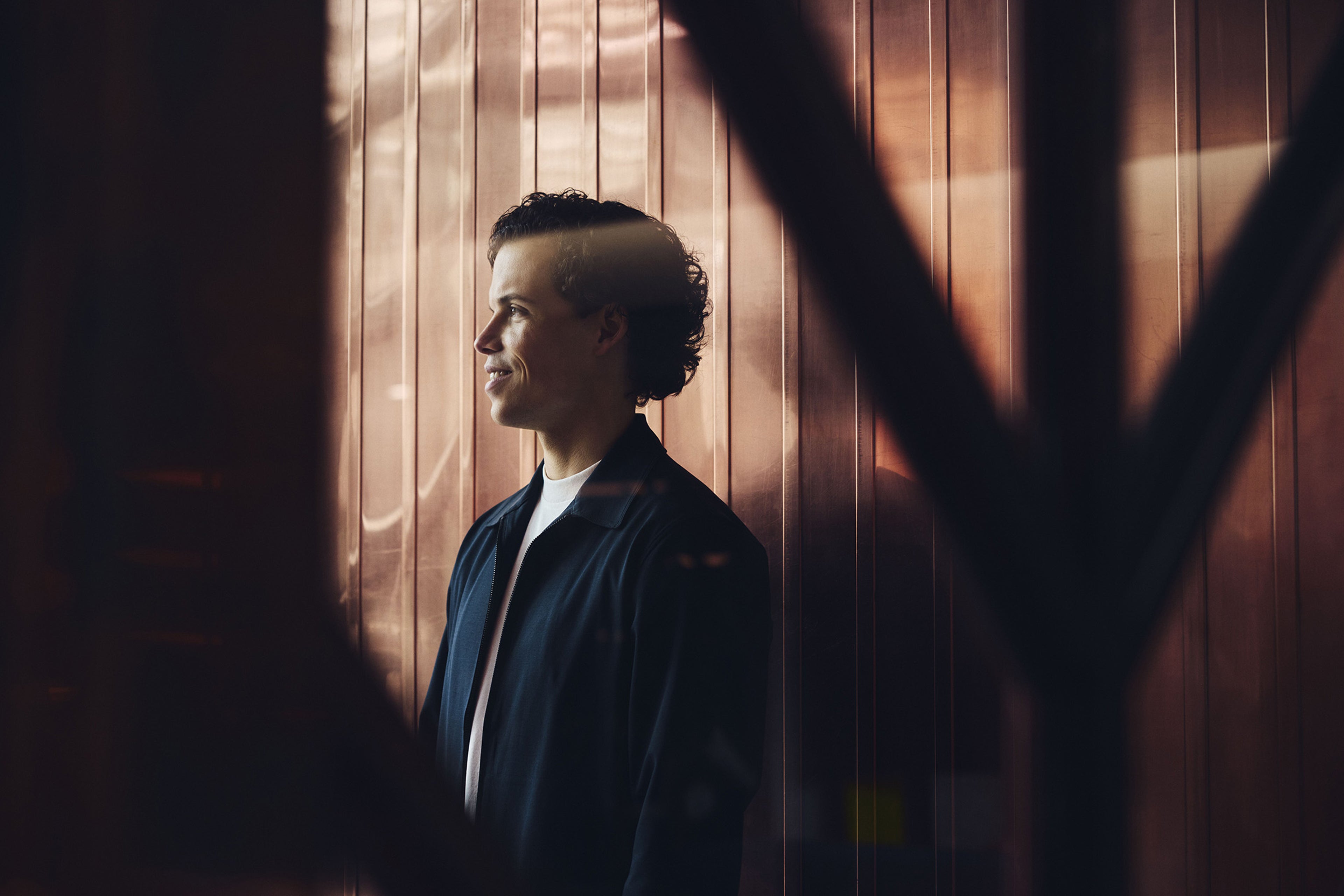 Man smiling standing in doorway.