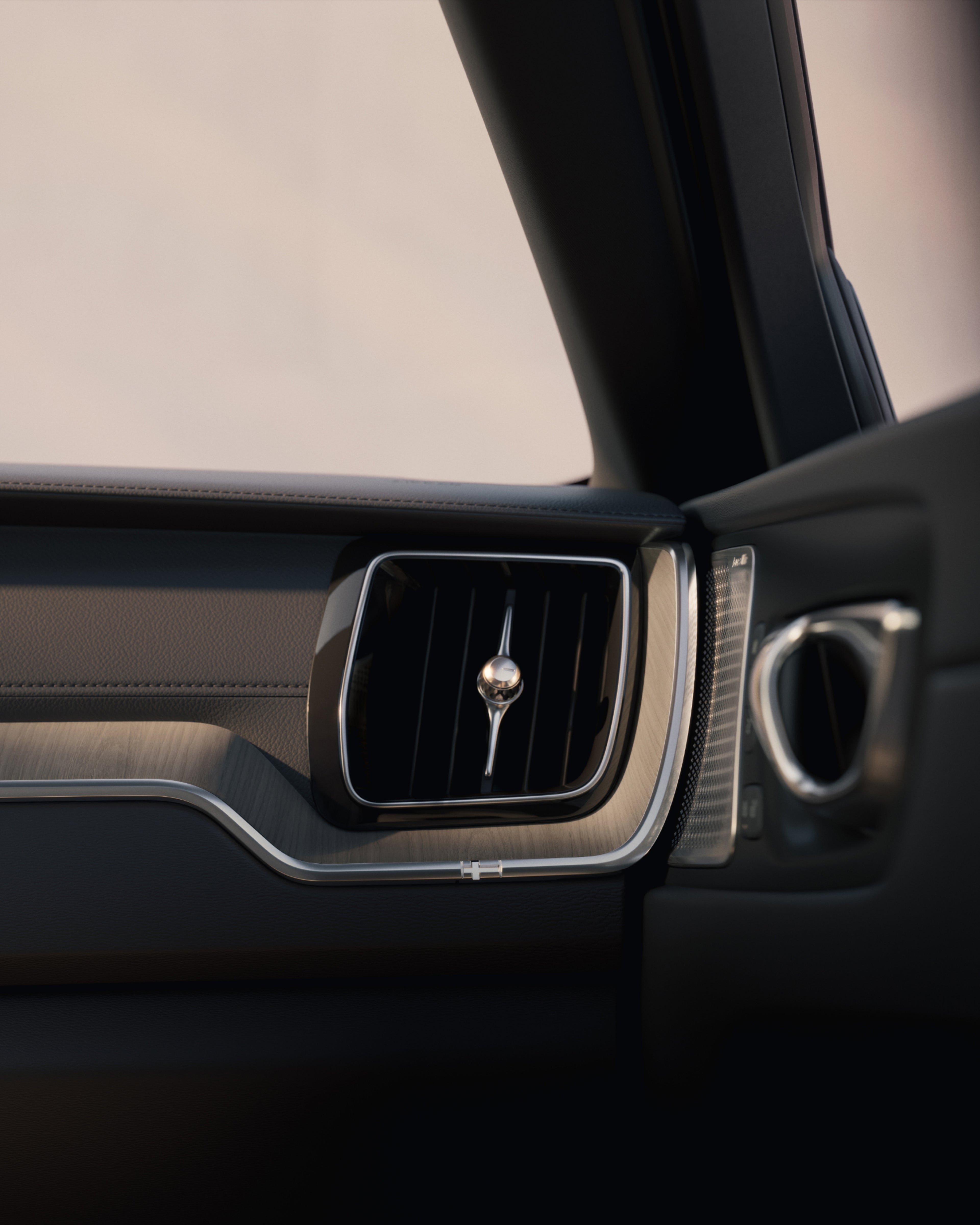 Detalle del interior del Volvo XC60, destacando la decoración y rejilla de ventilación.