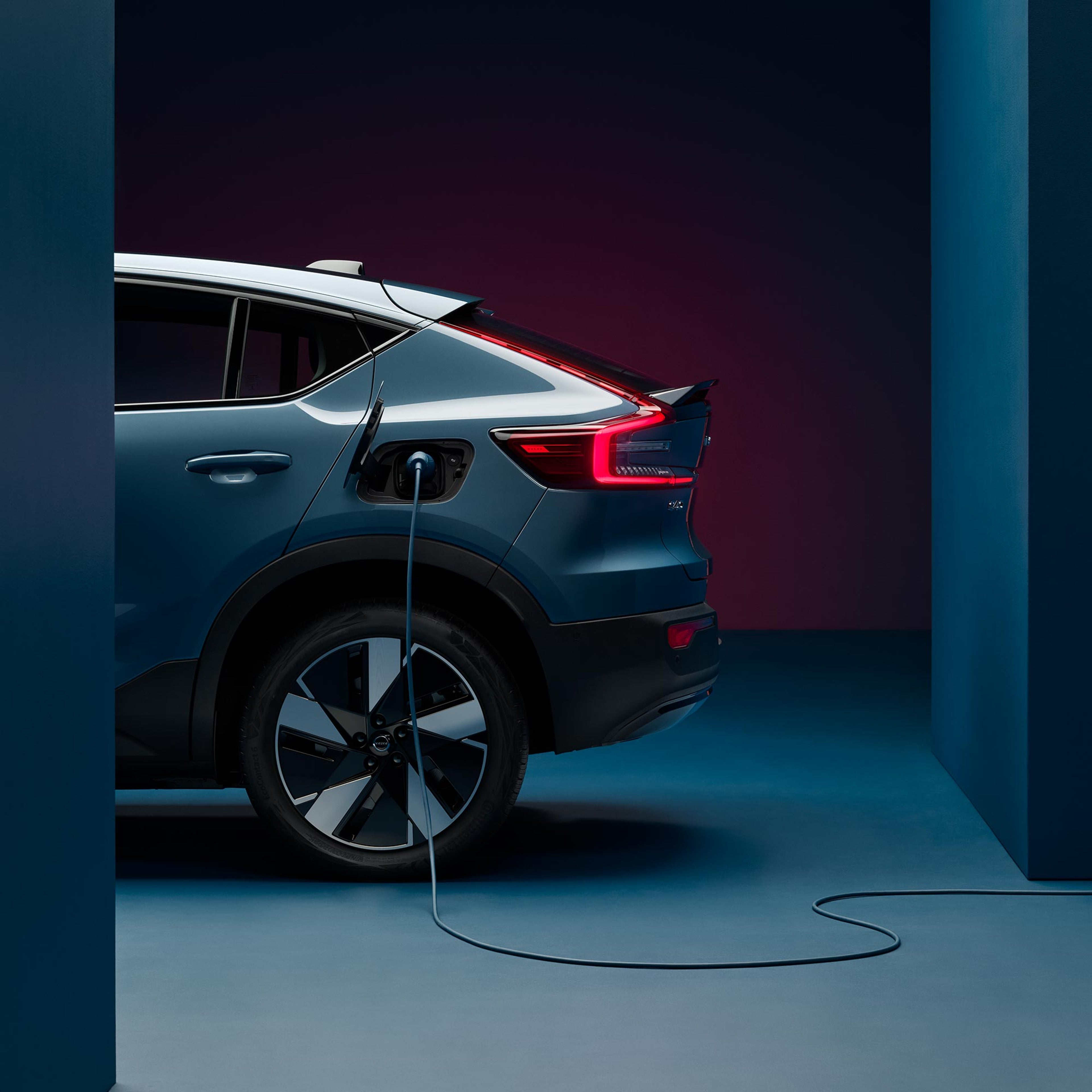 Volvo C40 Recharge in Fjord blue color with charging cable.