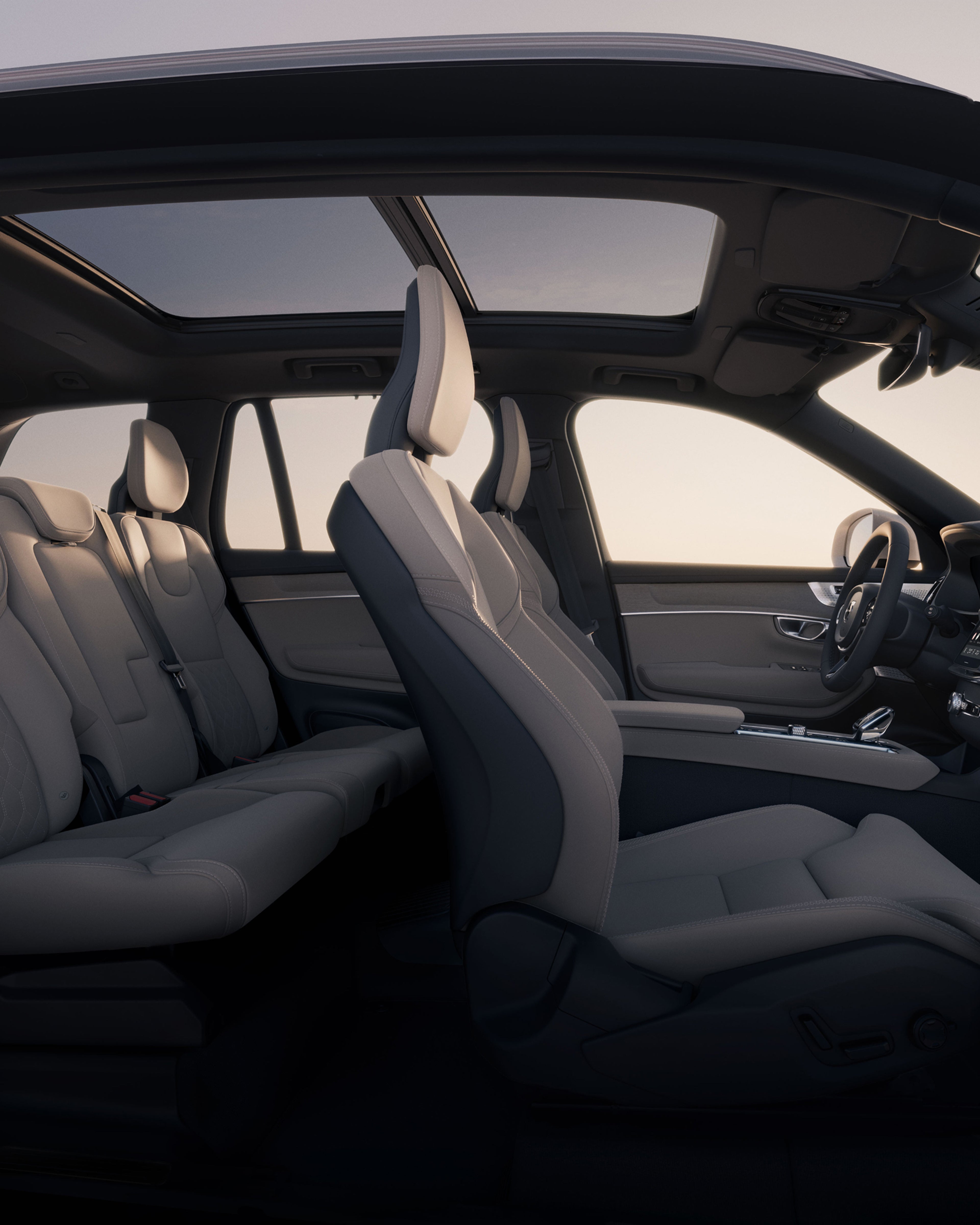 Open side view of the spacious interior and panoramic roof of the Volvo XC90.
