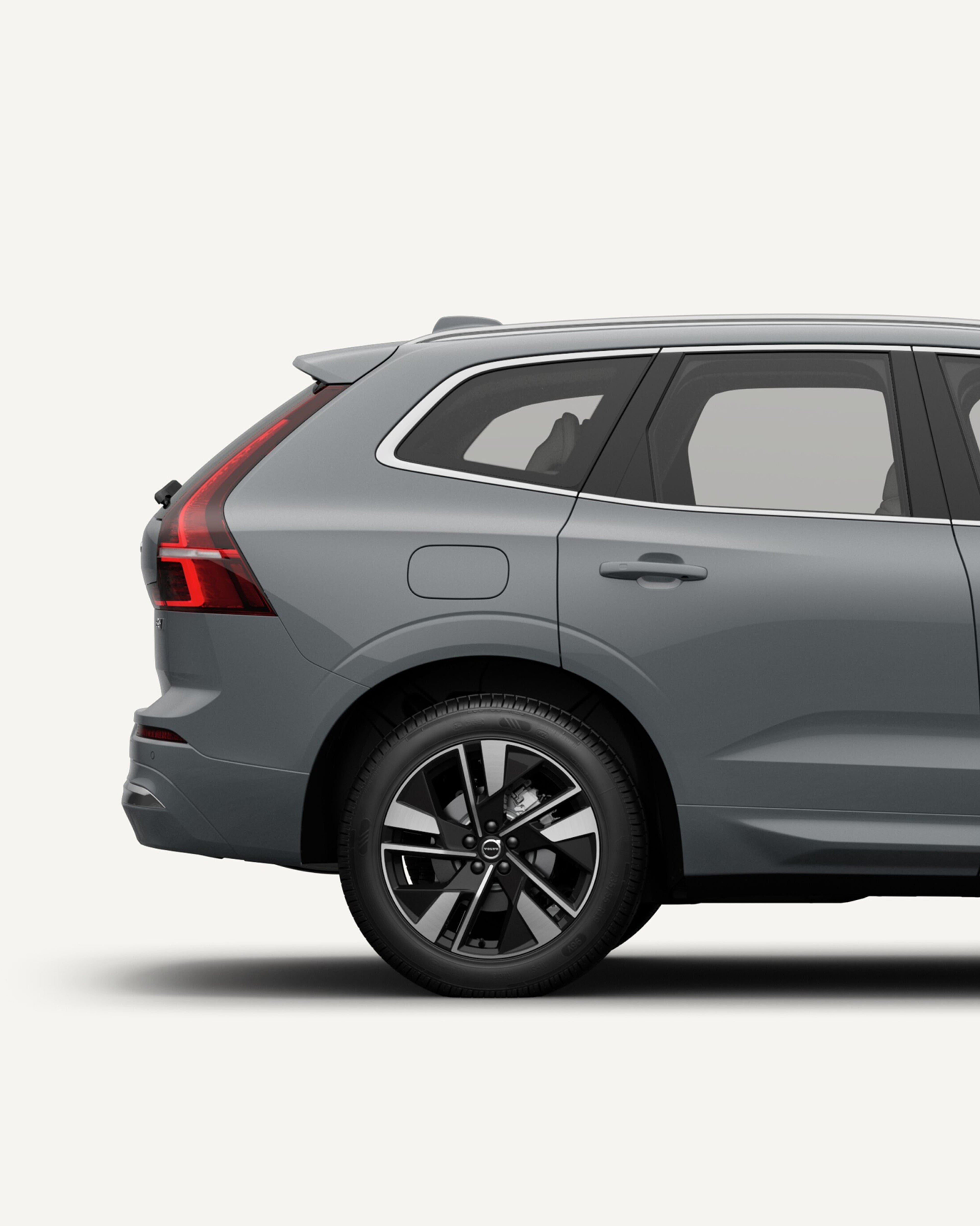 The open rear load compartment the Volvo XC60 midsize mild hybrid SUV in a white studio environment.