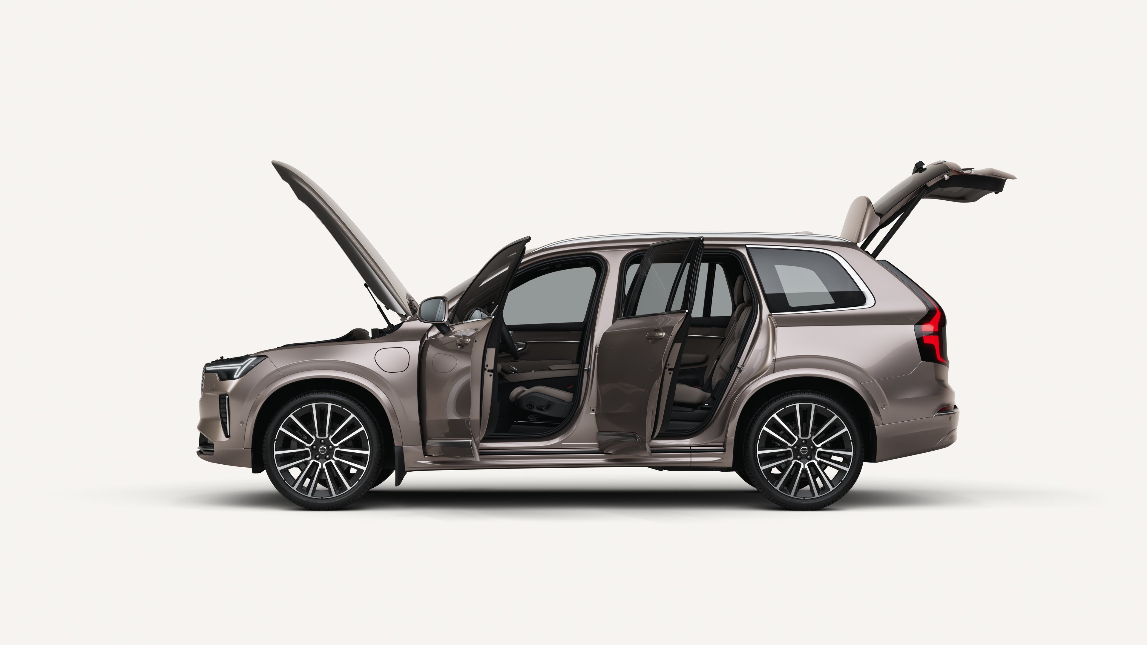 Side view of the Volvo XC90 plug-in hybrid with open hood, doors, and trunk in a white studio environment.