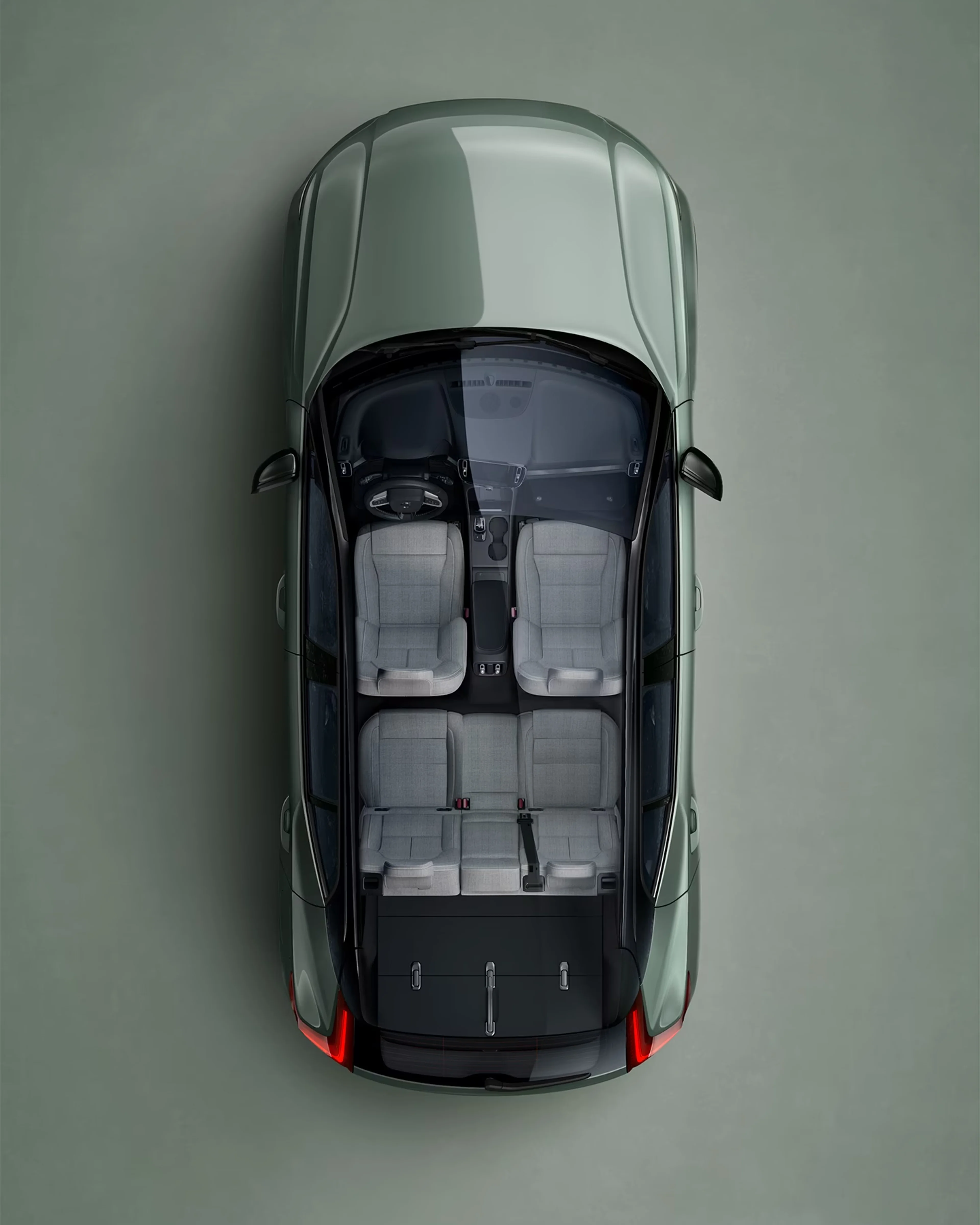 Um Volvo XC40 Recharge verde visto diretamente de cima com o interior visível.