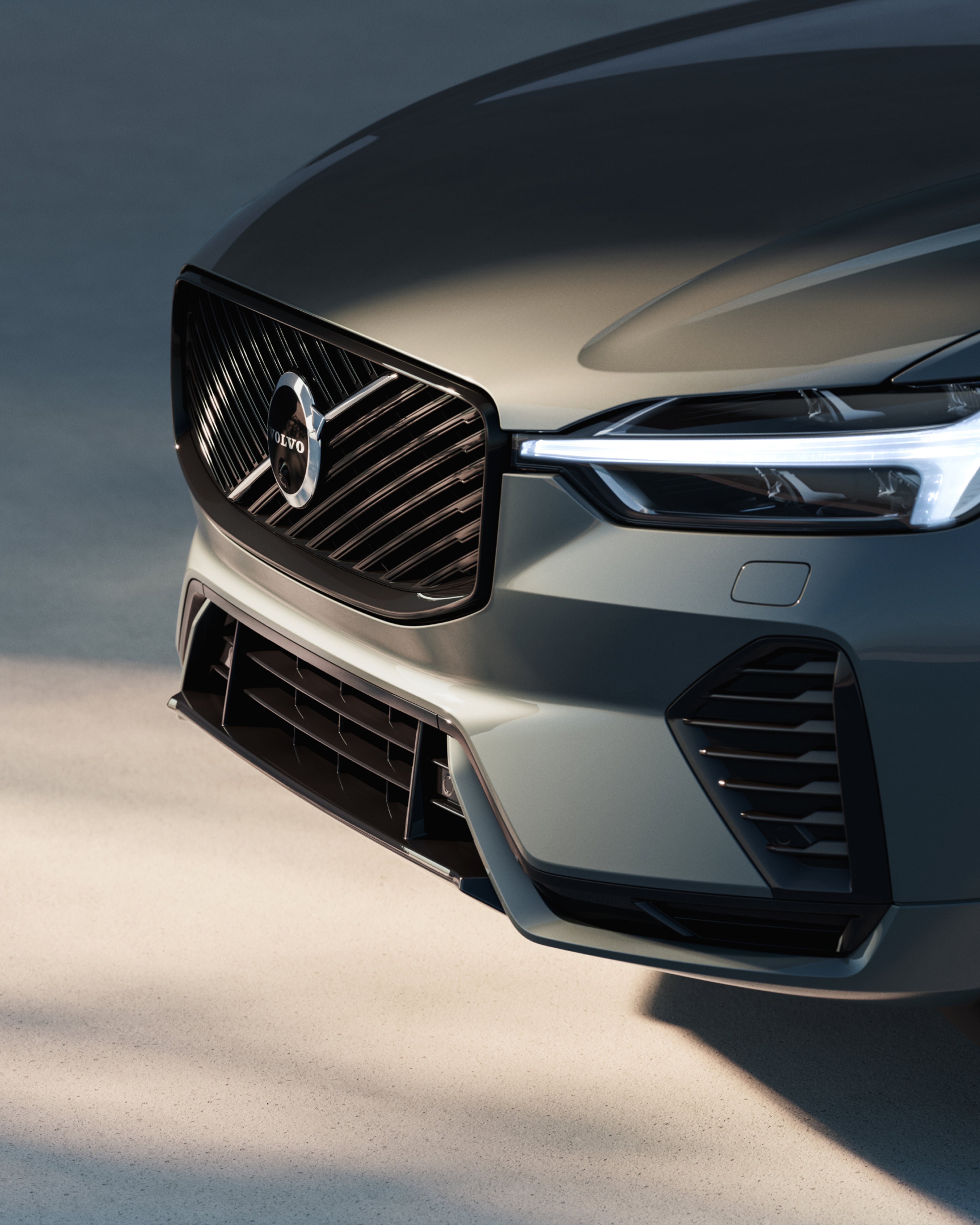 La parte delantera de un SUV híbrido enchufable Volvo XC60 mostrando su parrilla y faros LED.