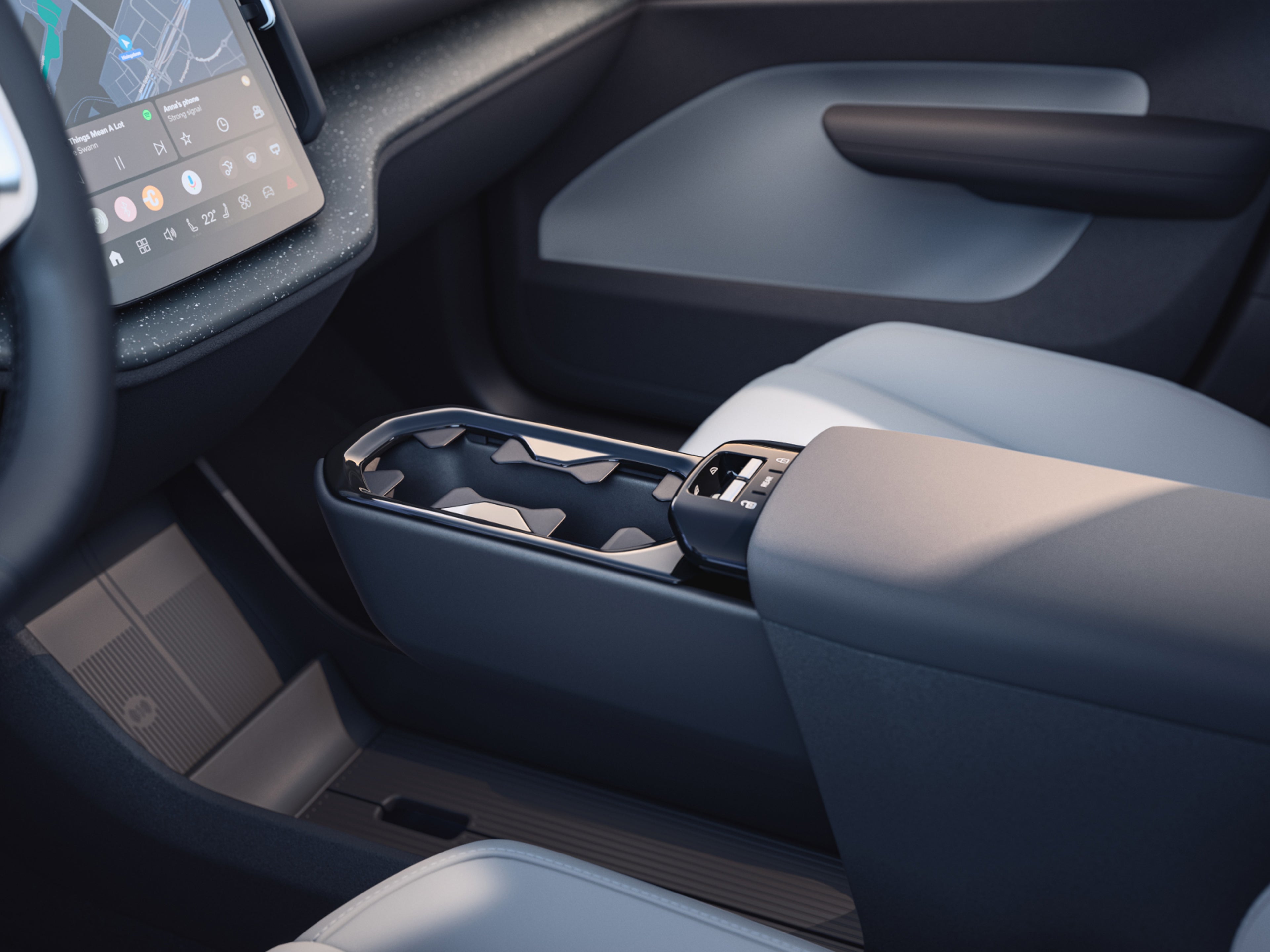 Close-up of the EX30's innovative multi-storage area and cupholder.