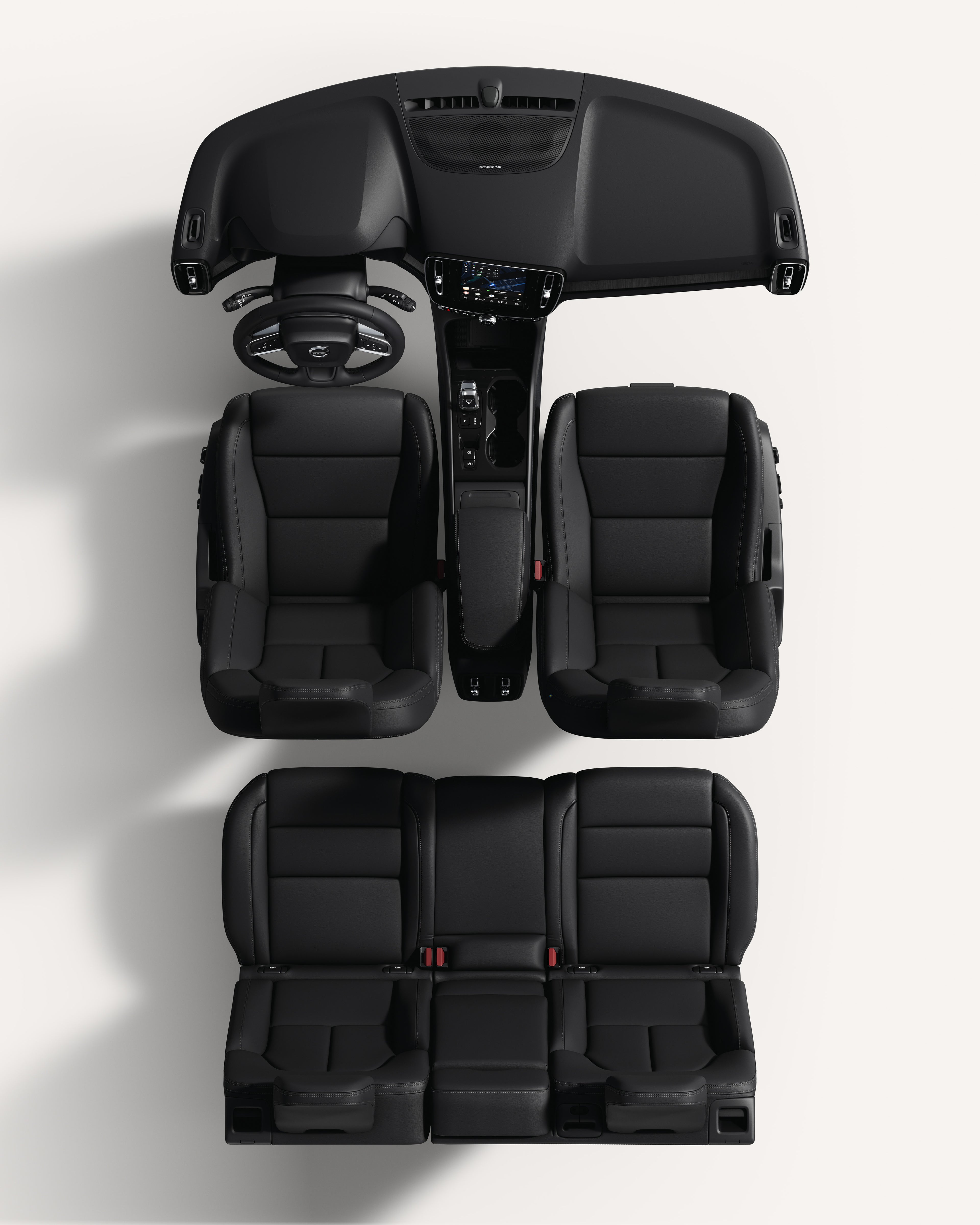 Поглед од горе надолу на ентериерот на Volvo XC40, со седишта и централна конзола во бела студиска атмосфера.