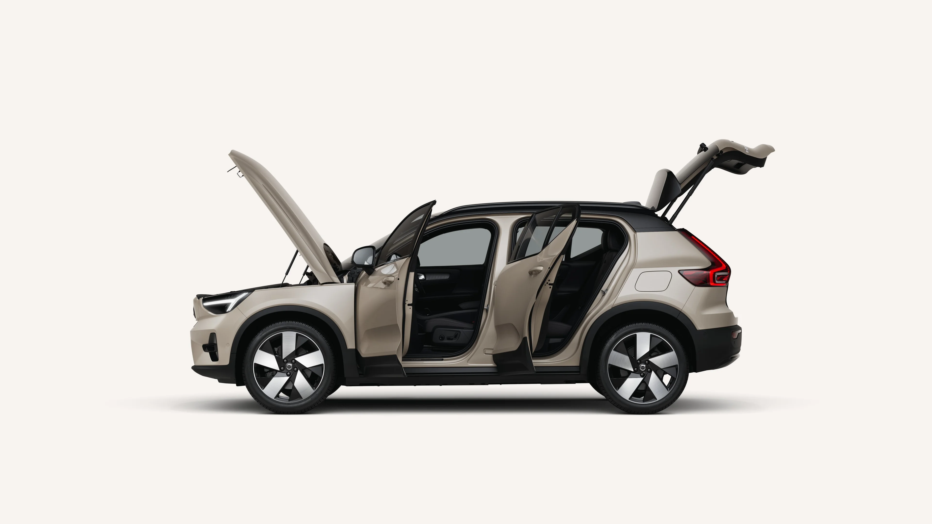 Side view of the Volvo EX40 with open hood, doors, and trunk in a white studio environment.
