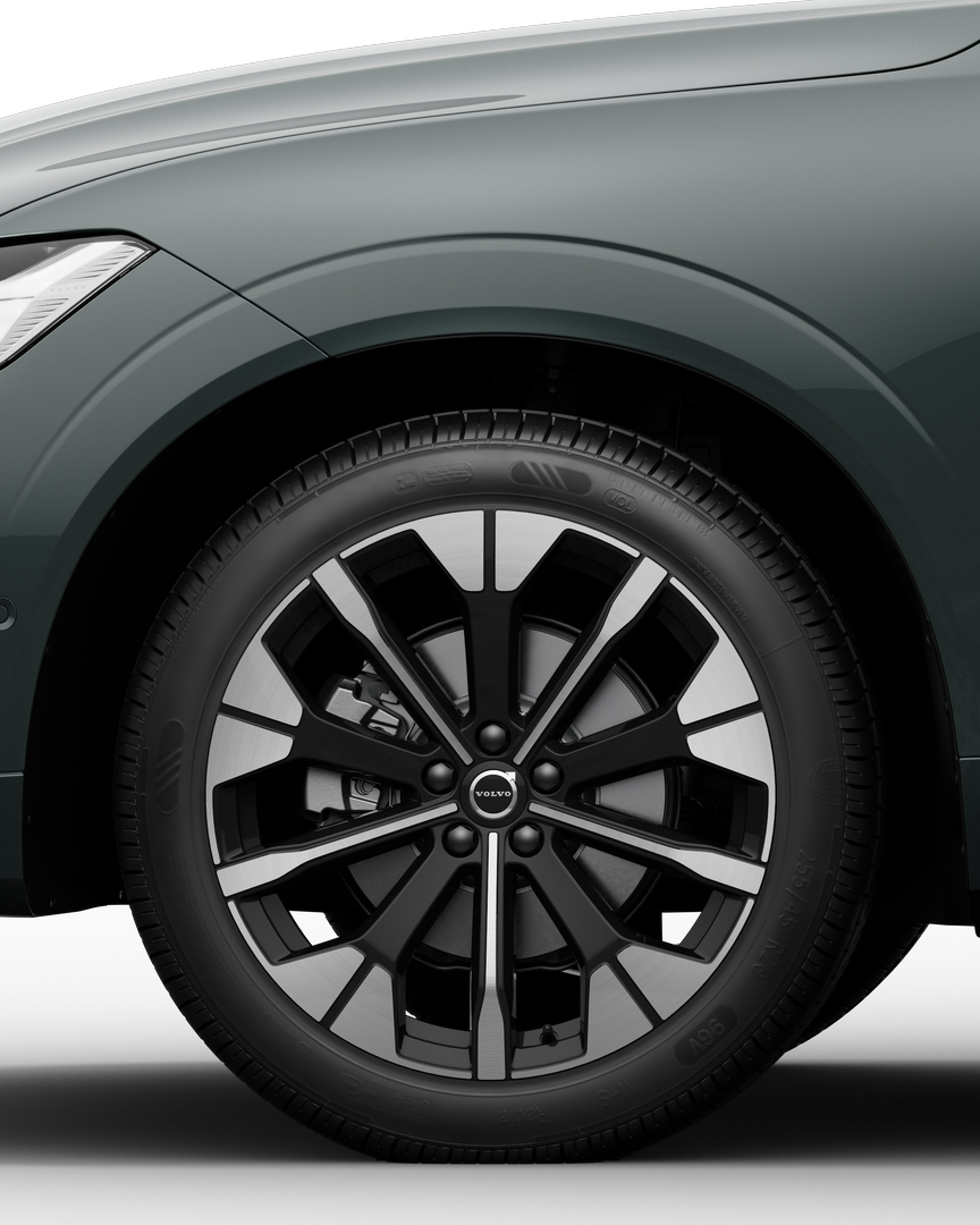 Front half of the Volvo XC60 midsize mild hybrid SUV in a white studio environment.