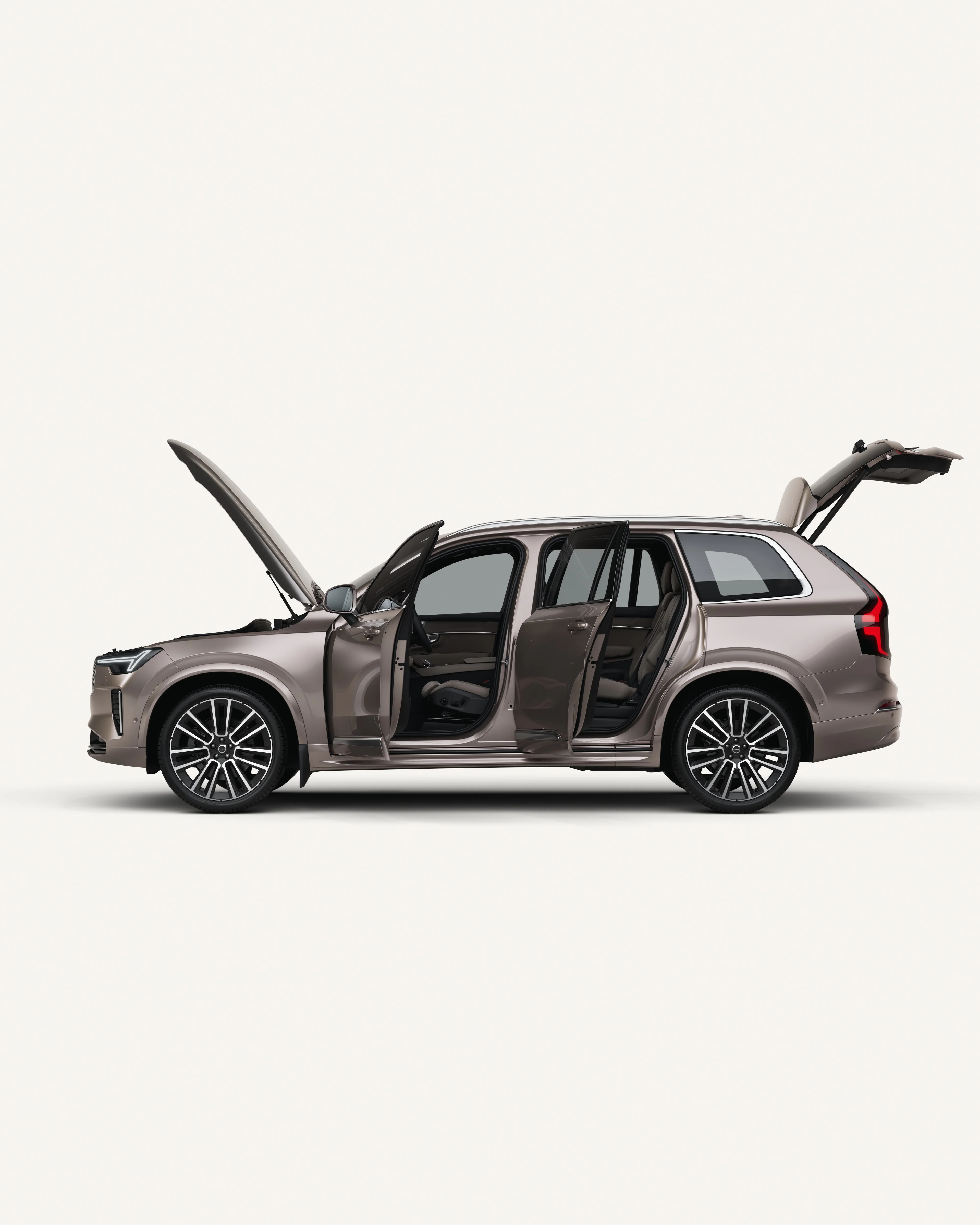 Side view of the Volvo XC90 with open hood, doors, and trunk in a white studio environment.