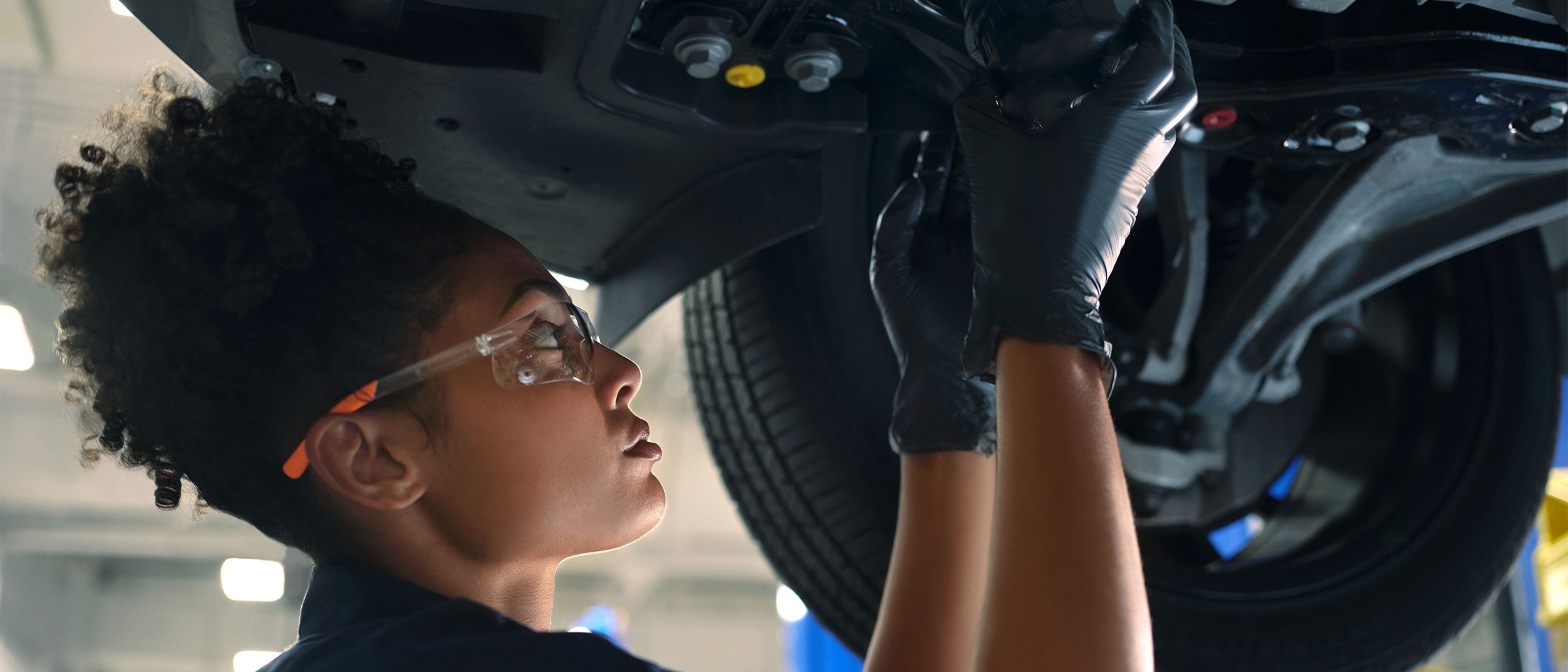 Female technician performing maintenance on a Volvo.