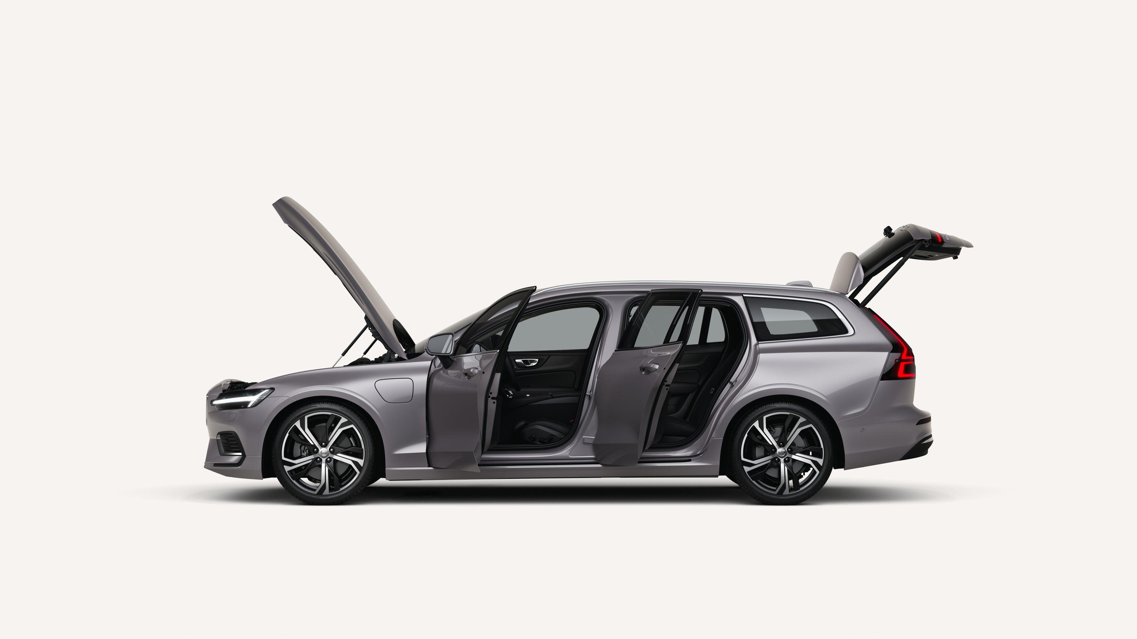 Side view of the Volvo V60 with open hood, doors, and trunk in a white studio environment.