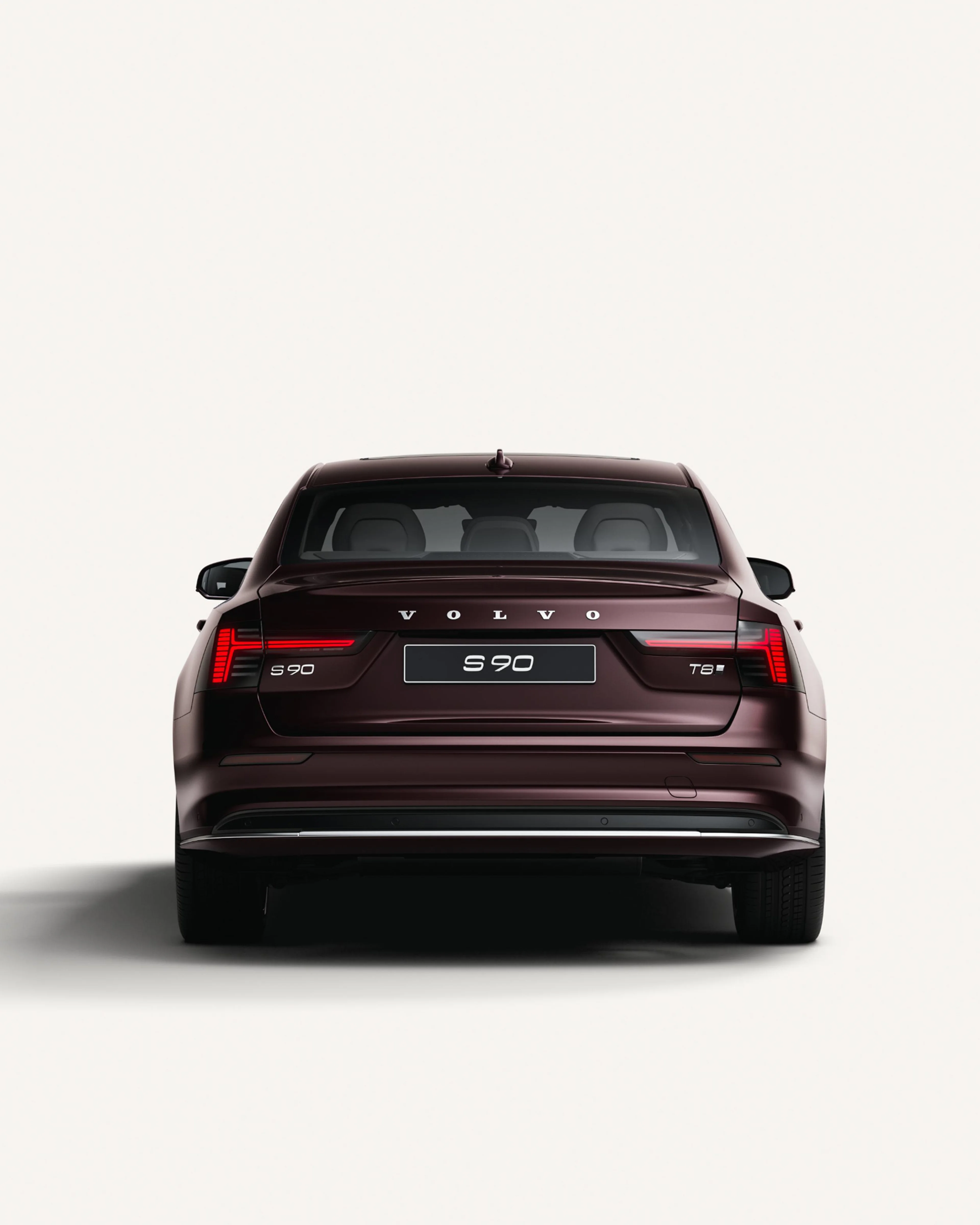Rear view of the Volvo S90 in a white studio environment.