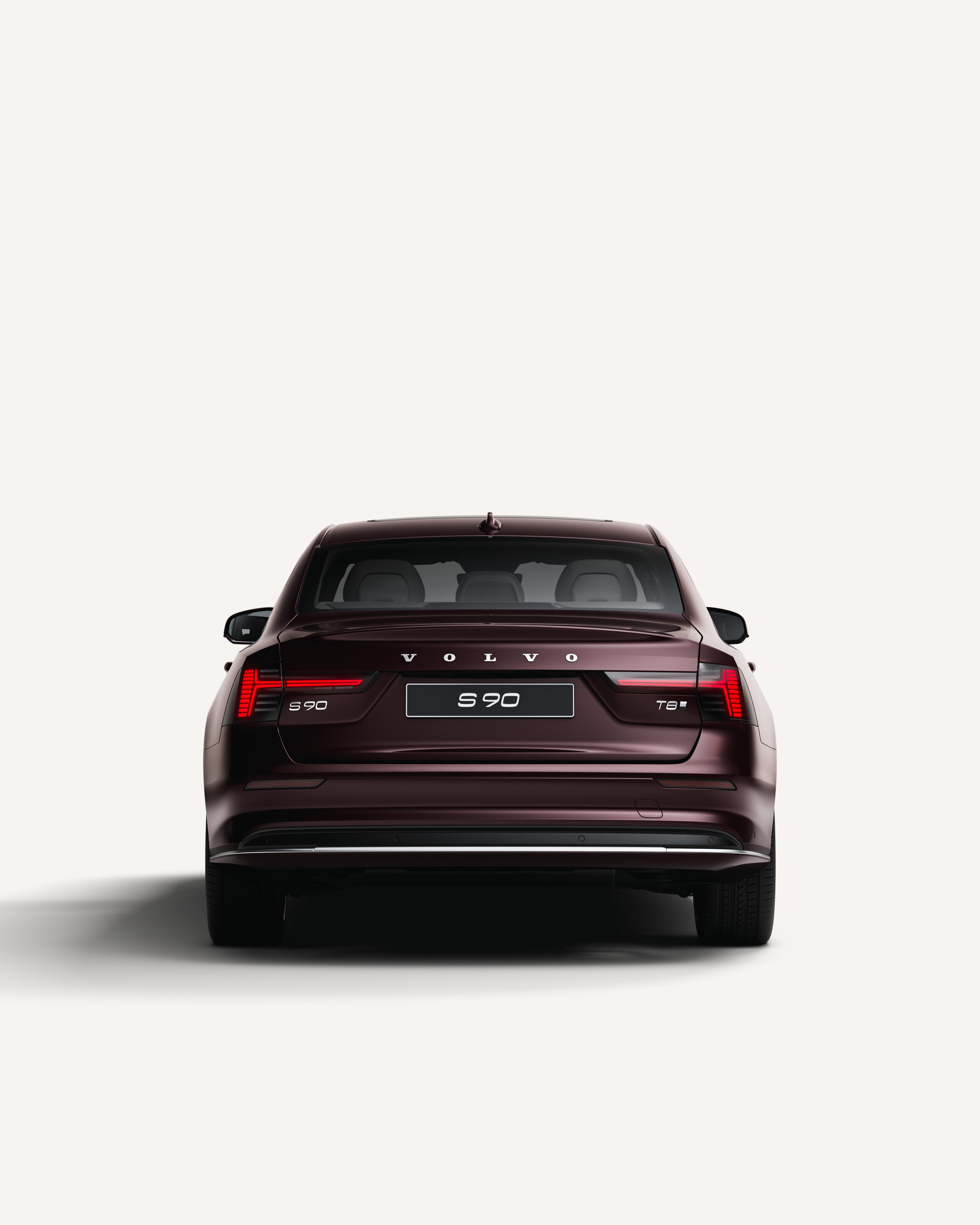 Rear view of the Volvo S90 in a white studio environment.