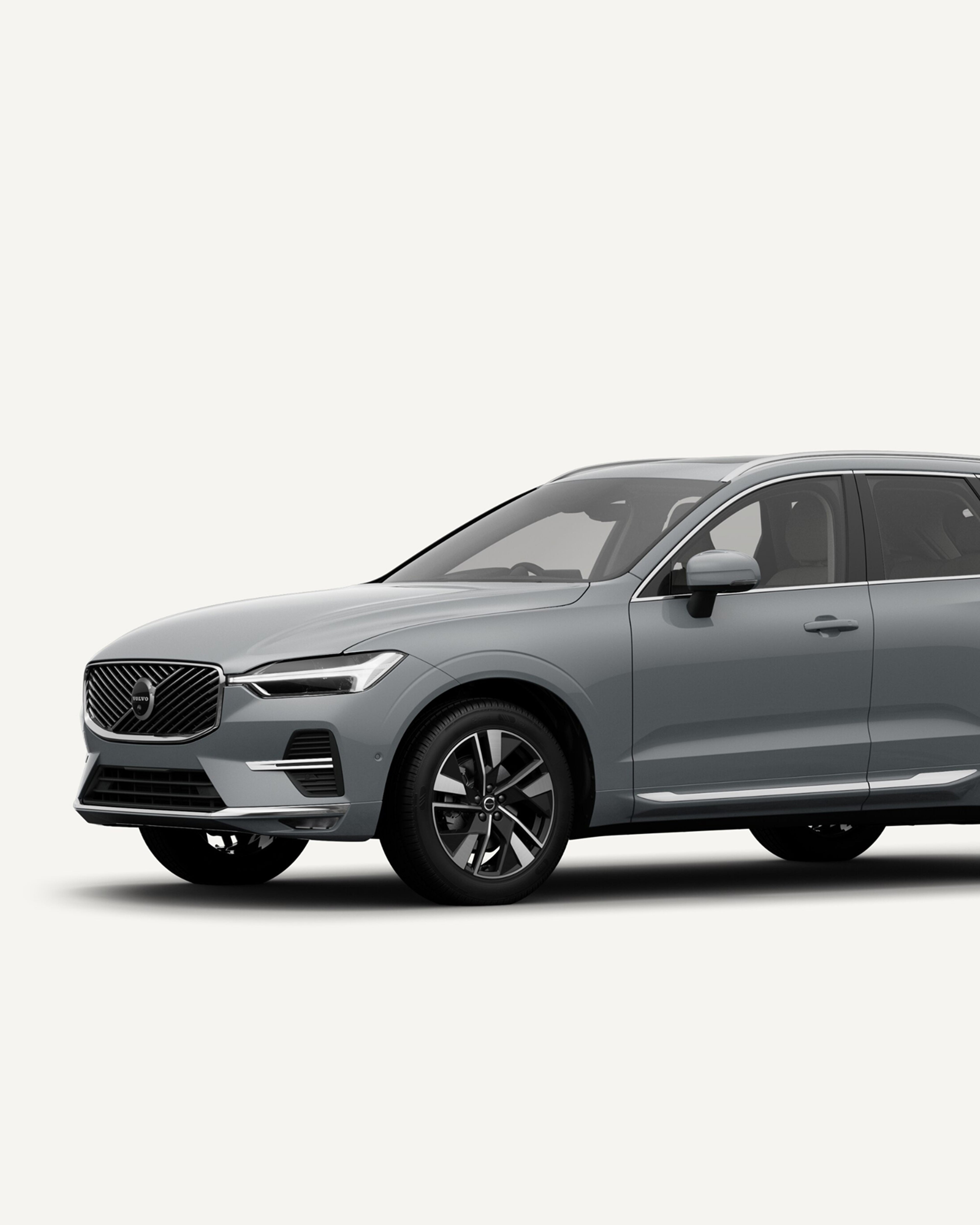 Side view of the Volvo XC60 midsize mild-hybrid SUV in a white studio environment.
