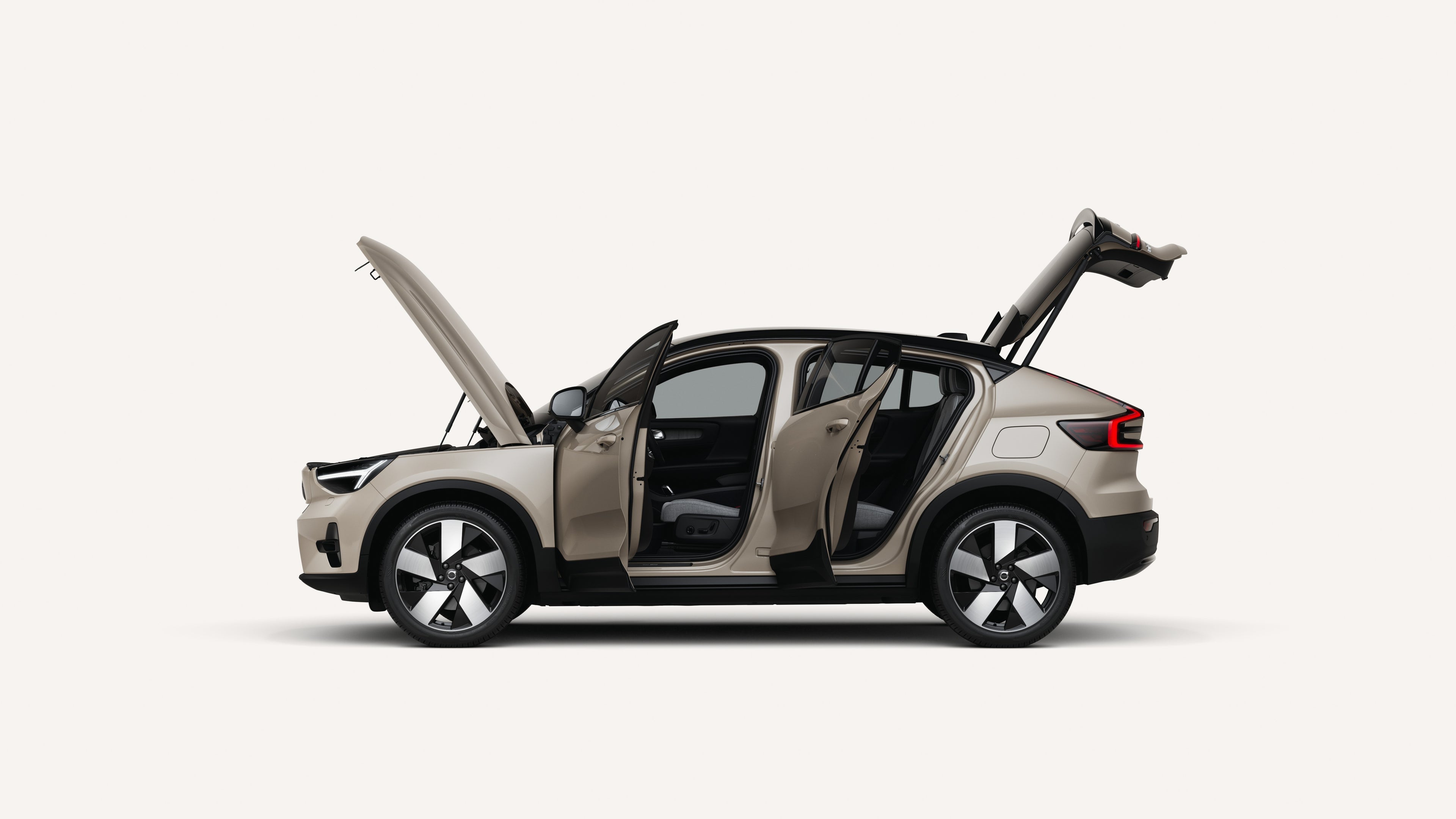 Side view of the Volvo EC40 Electric with open hood, doors, and trunk in a white studio environment.