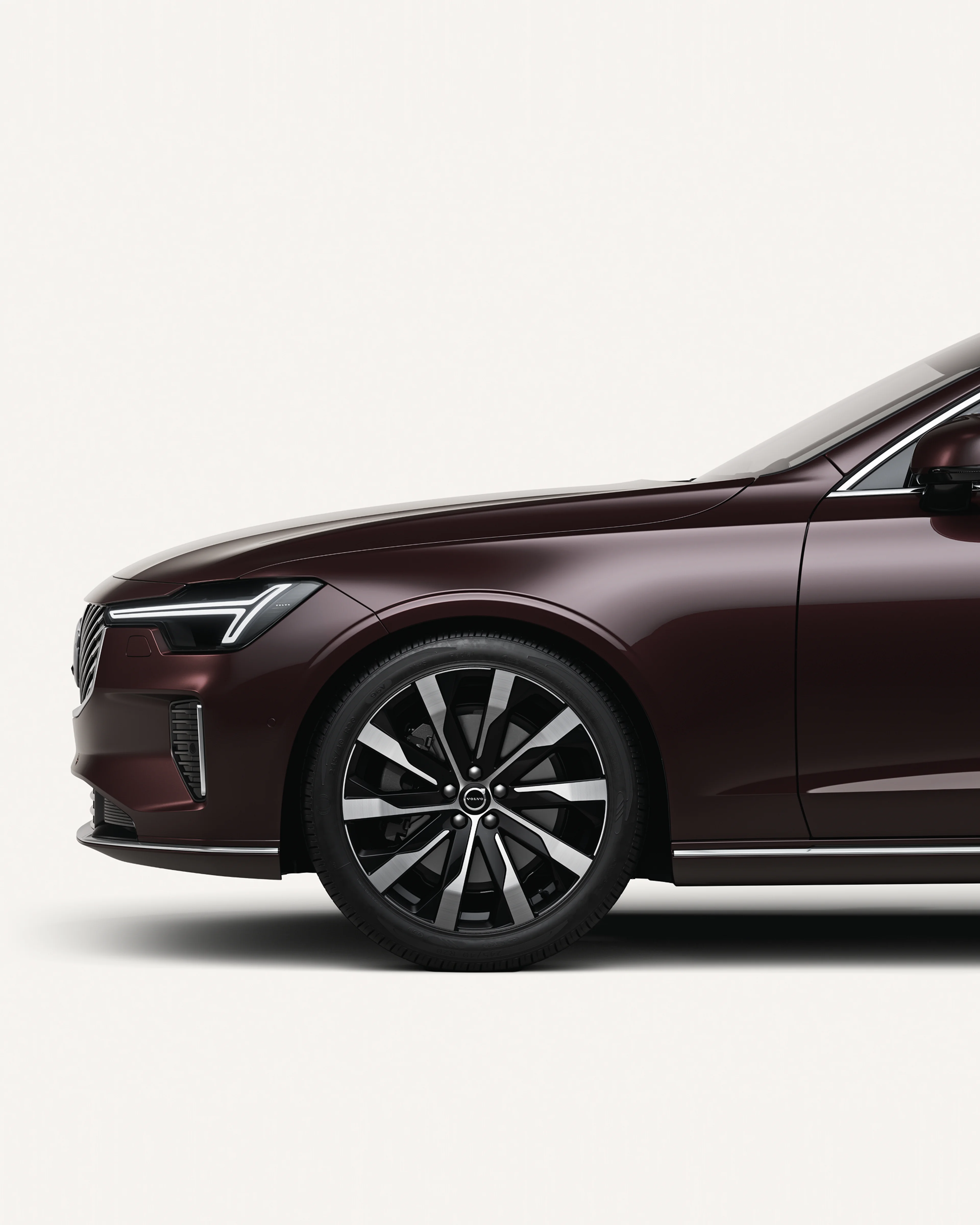 Front half of the Volvo S90 in a white studio environment.