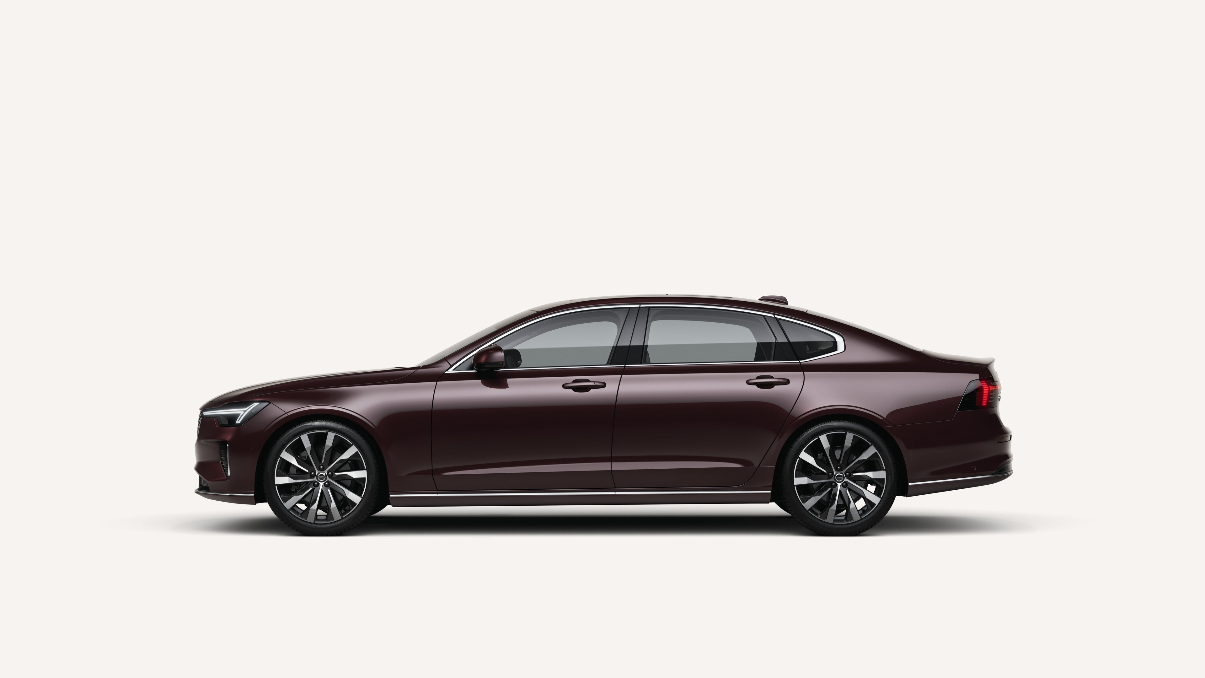 Side view of the Volvo S90 in a white studio environment.