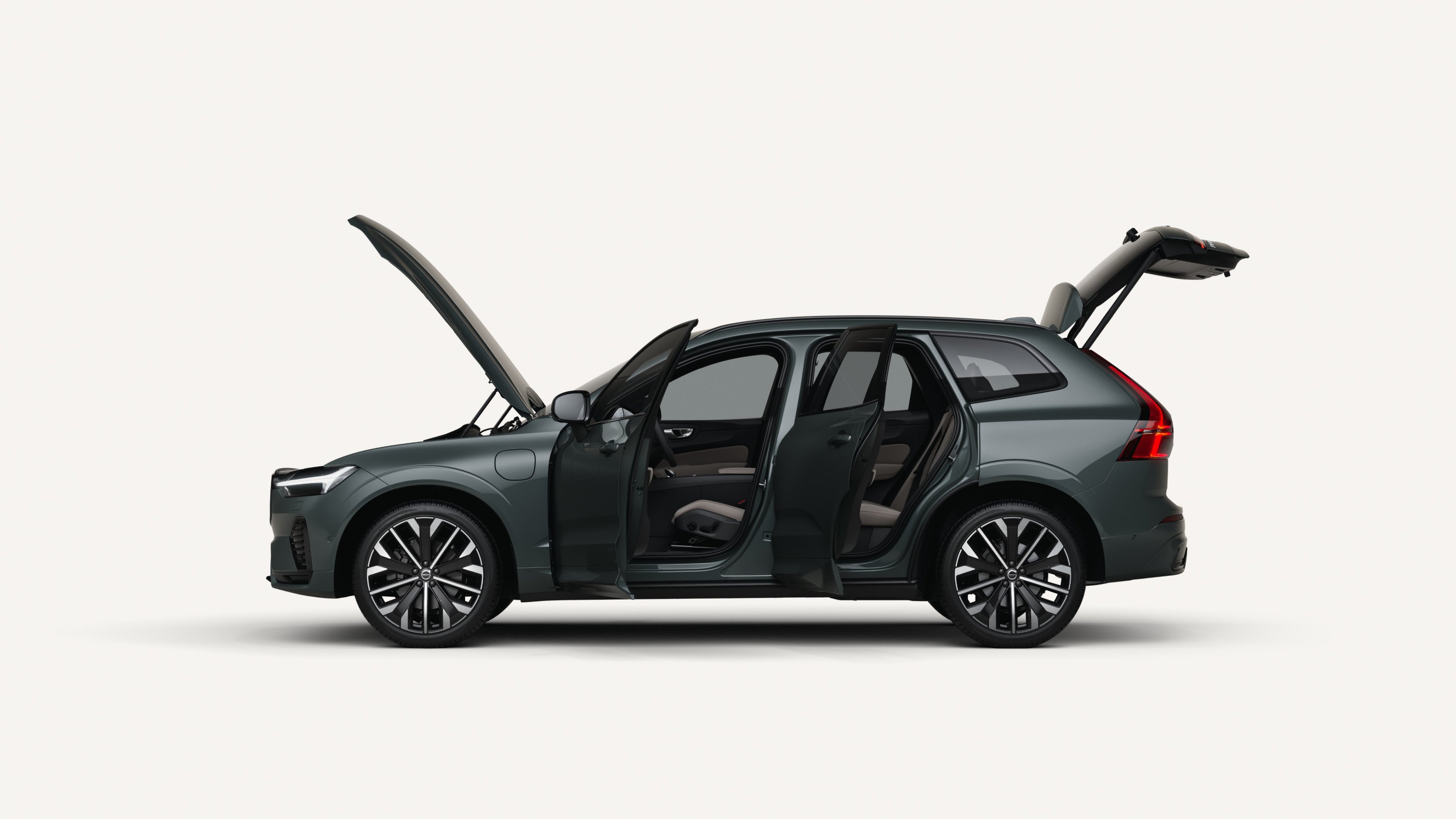 Side view of the Volvo XC60 plug-in hybrid with open hood, doors, and trunk in a white studio environment.