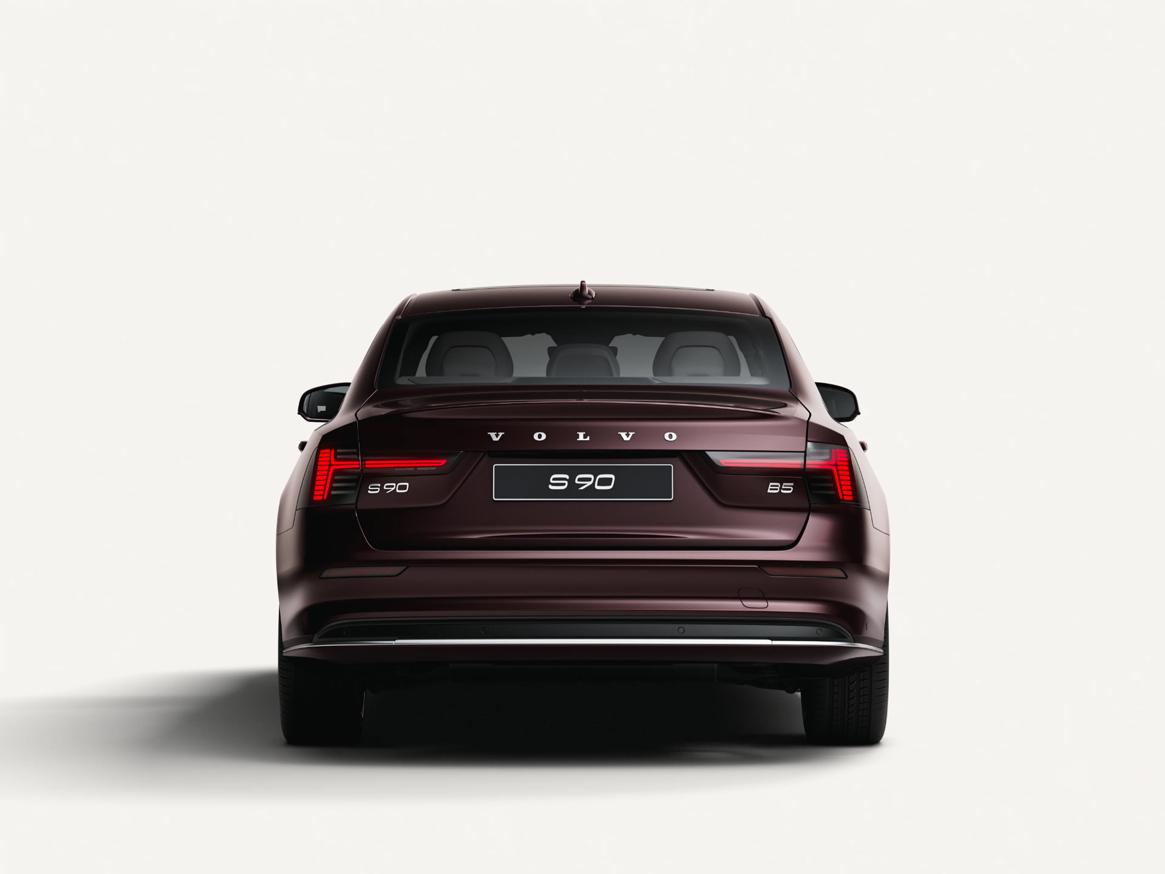 Rear view of the Volvo S90 in a white studio environment.