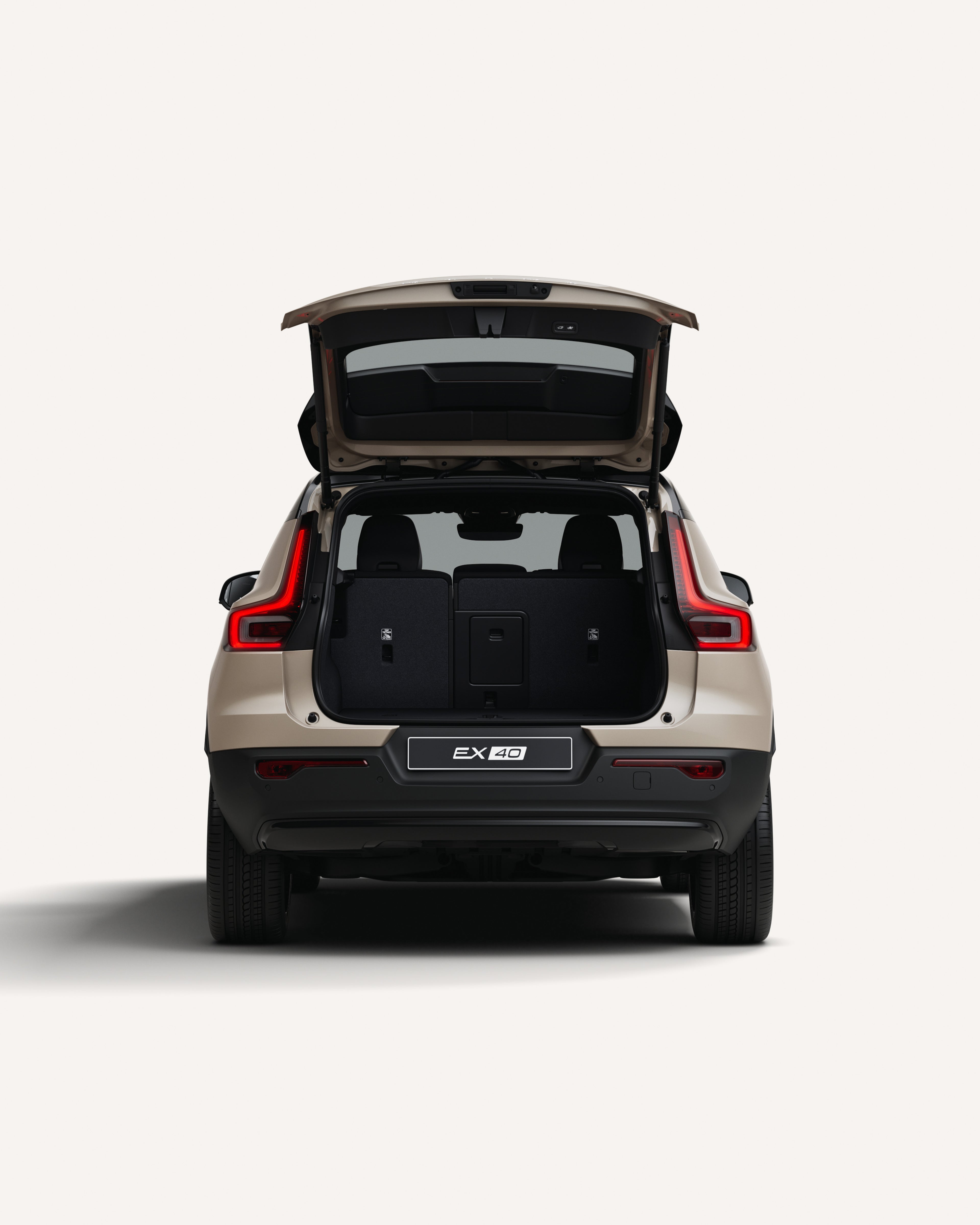 Rear view of the Volvo EX40 with the trunk open in a white studio environment.