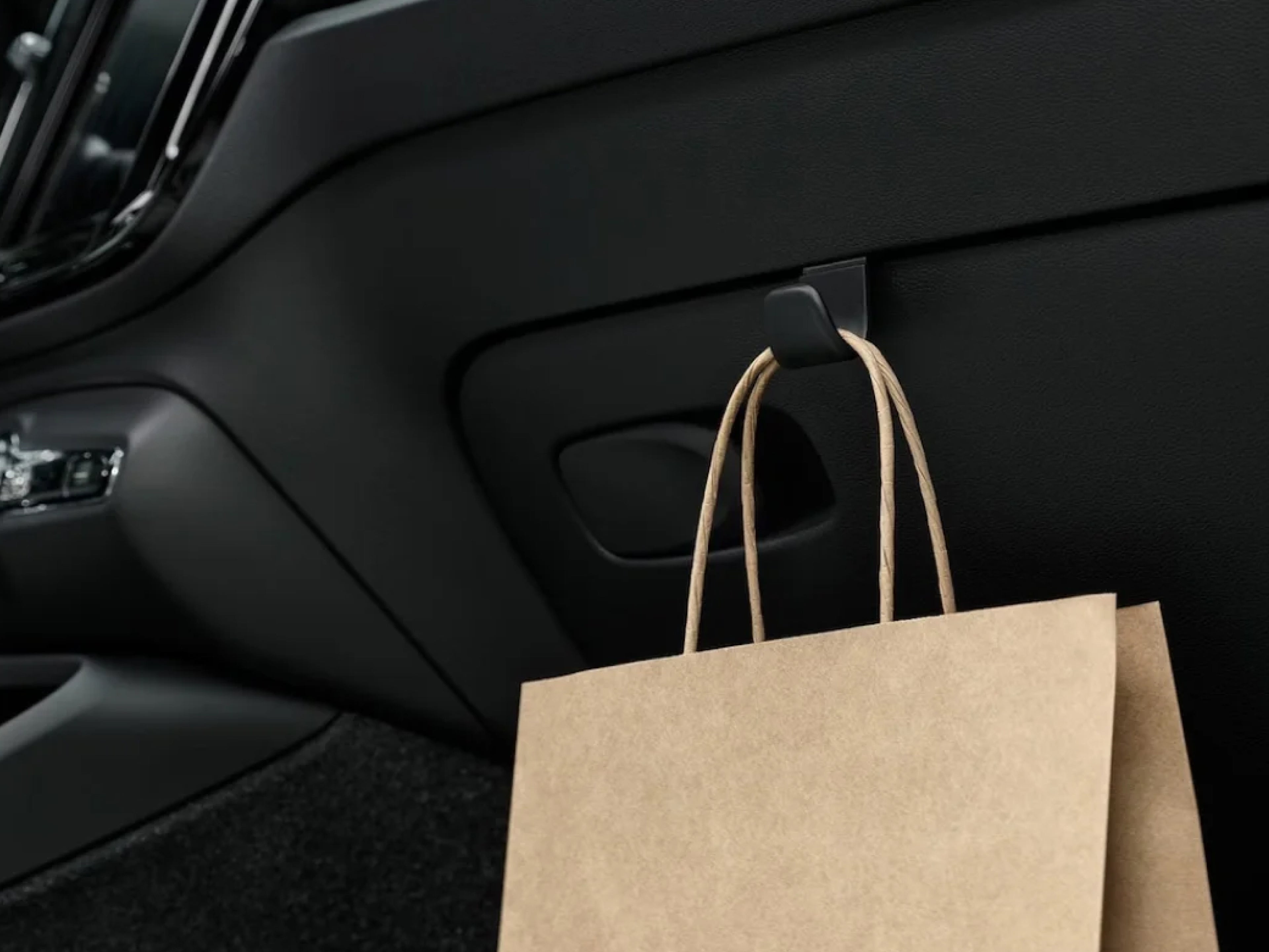 A discreet hook in the Volvo EX40 cabin holds a paper bag in place.