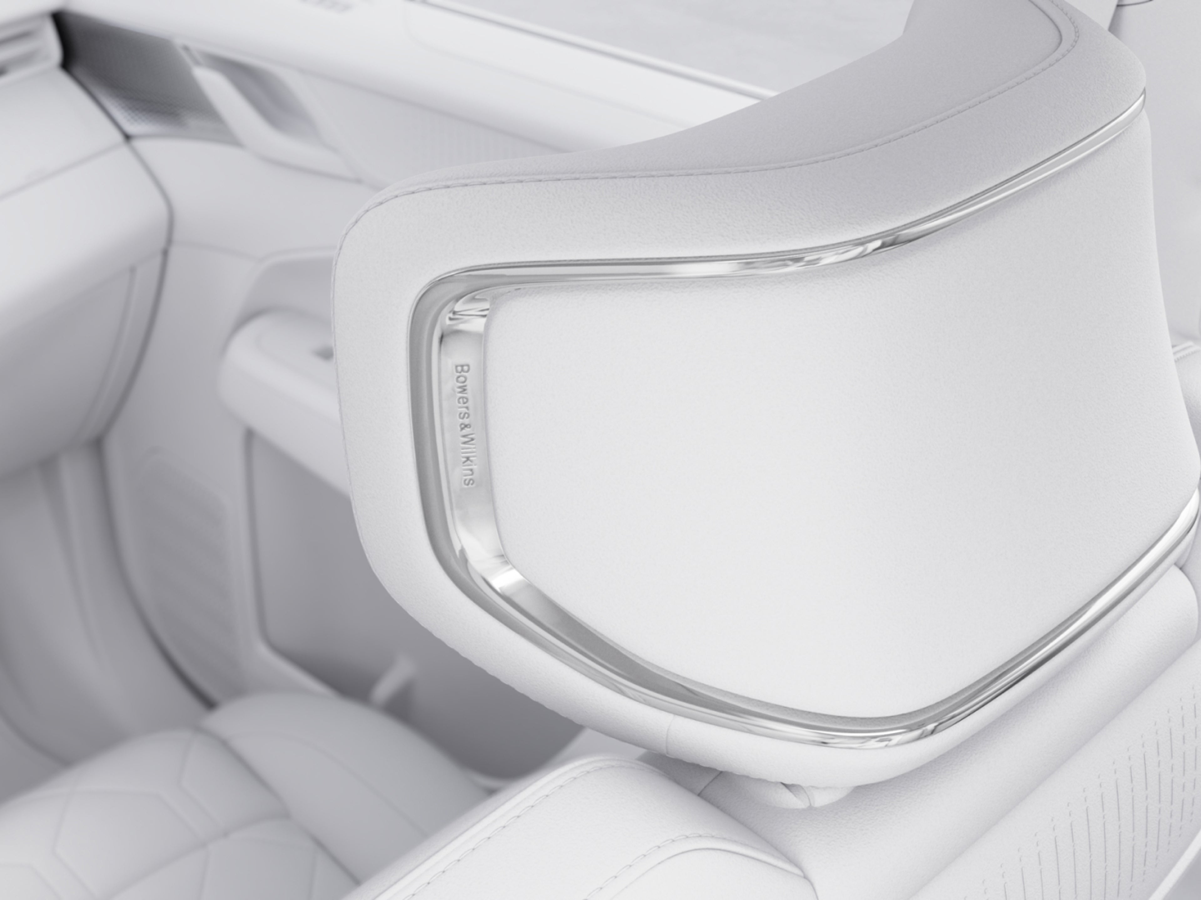Image of a sleek Bowers & Wilkins speaker discreetly integrated into a first-row headrest.