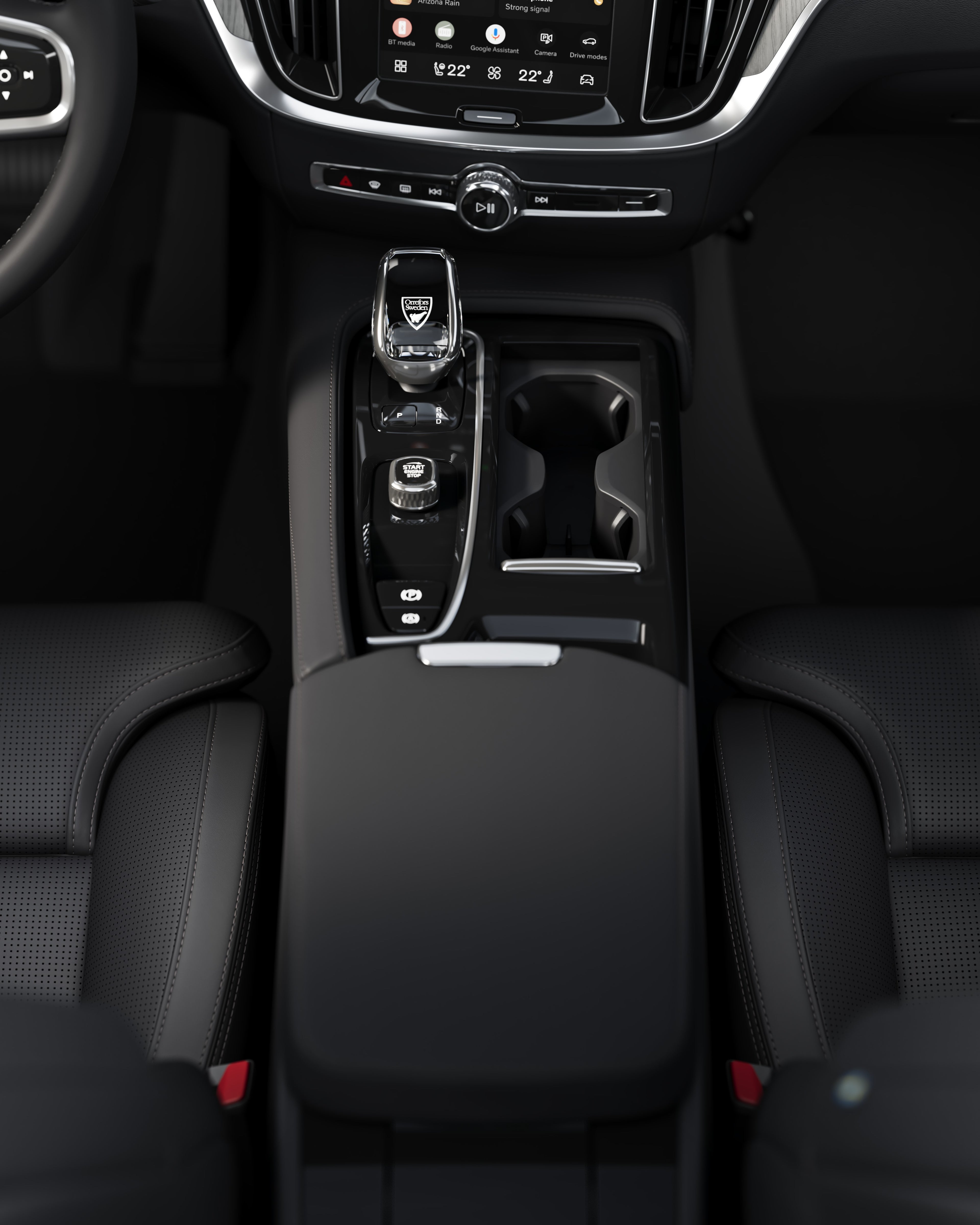 Close-up of the center console in a Volvo V60, including cup holders and gear shifter.