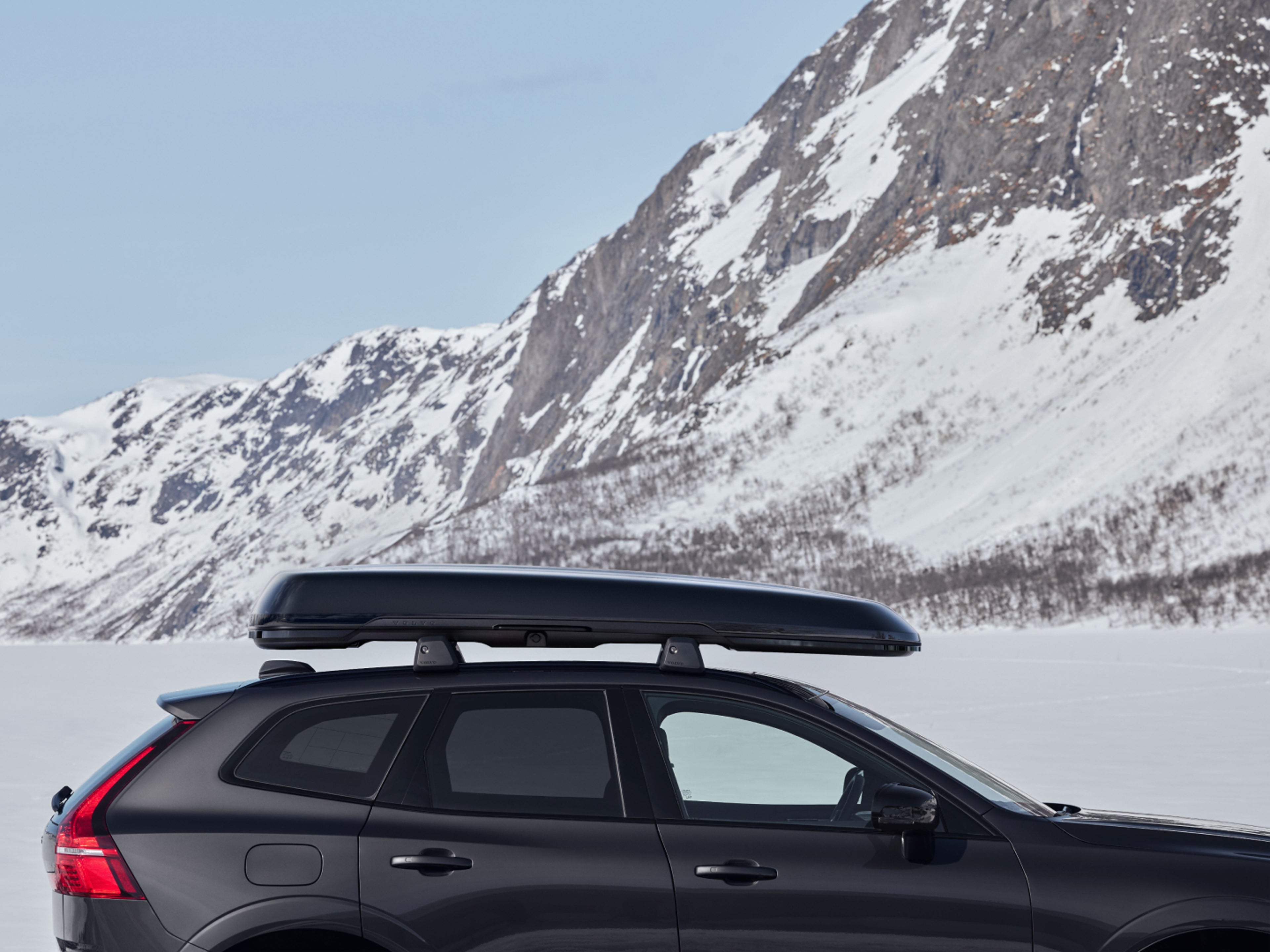 The Volvo XC60 Black Edition with a black roof box.
