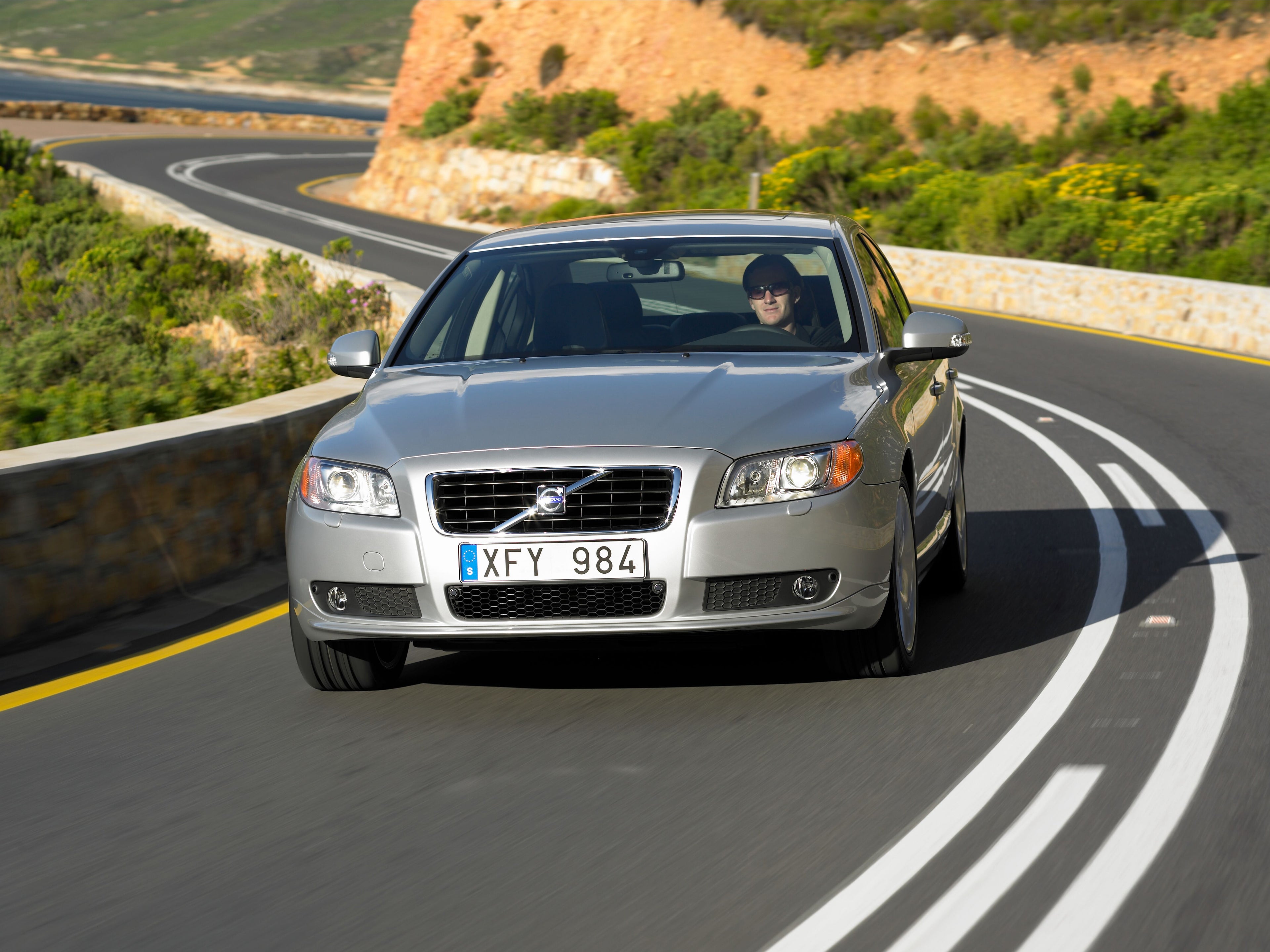 Picture of a Volvo S80 driving on a road.