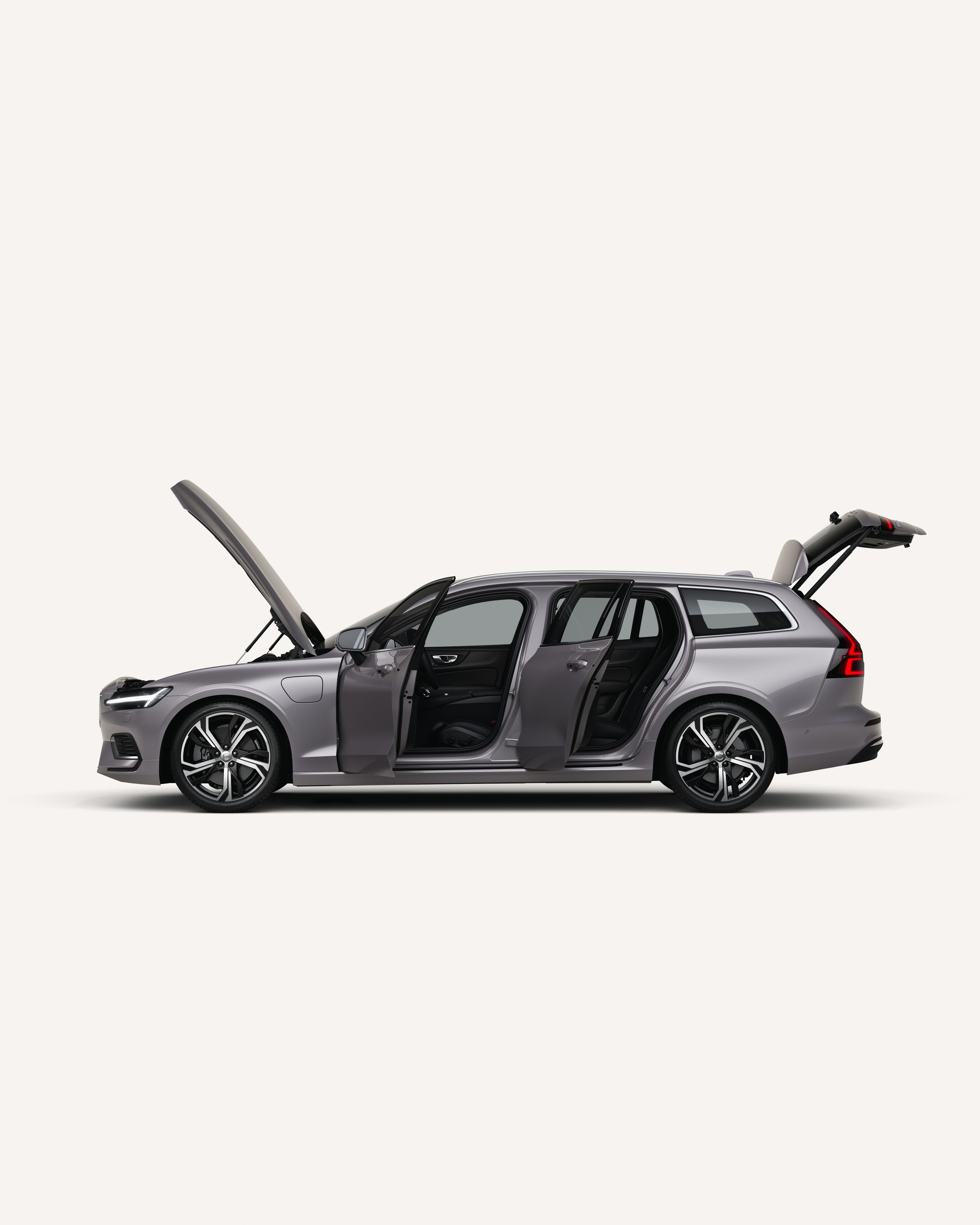Seitenansicht des Volvo V60 mit offener Motorhaube, Türen und Kofferraum in einer weißen Studioumgebung.