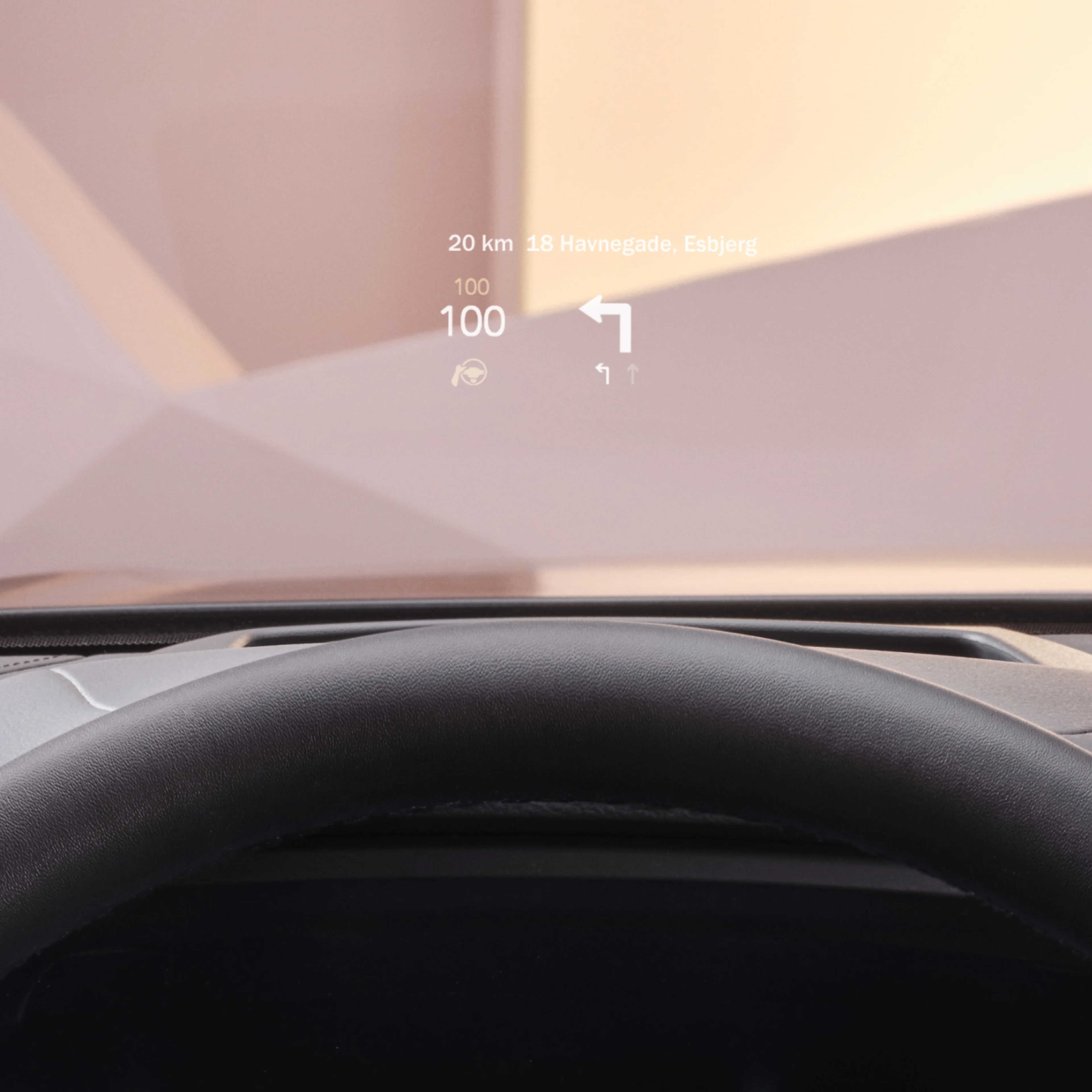 Inside a Volvo, head-up display showing driving speed and navigation on the windshield.