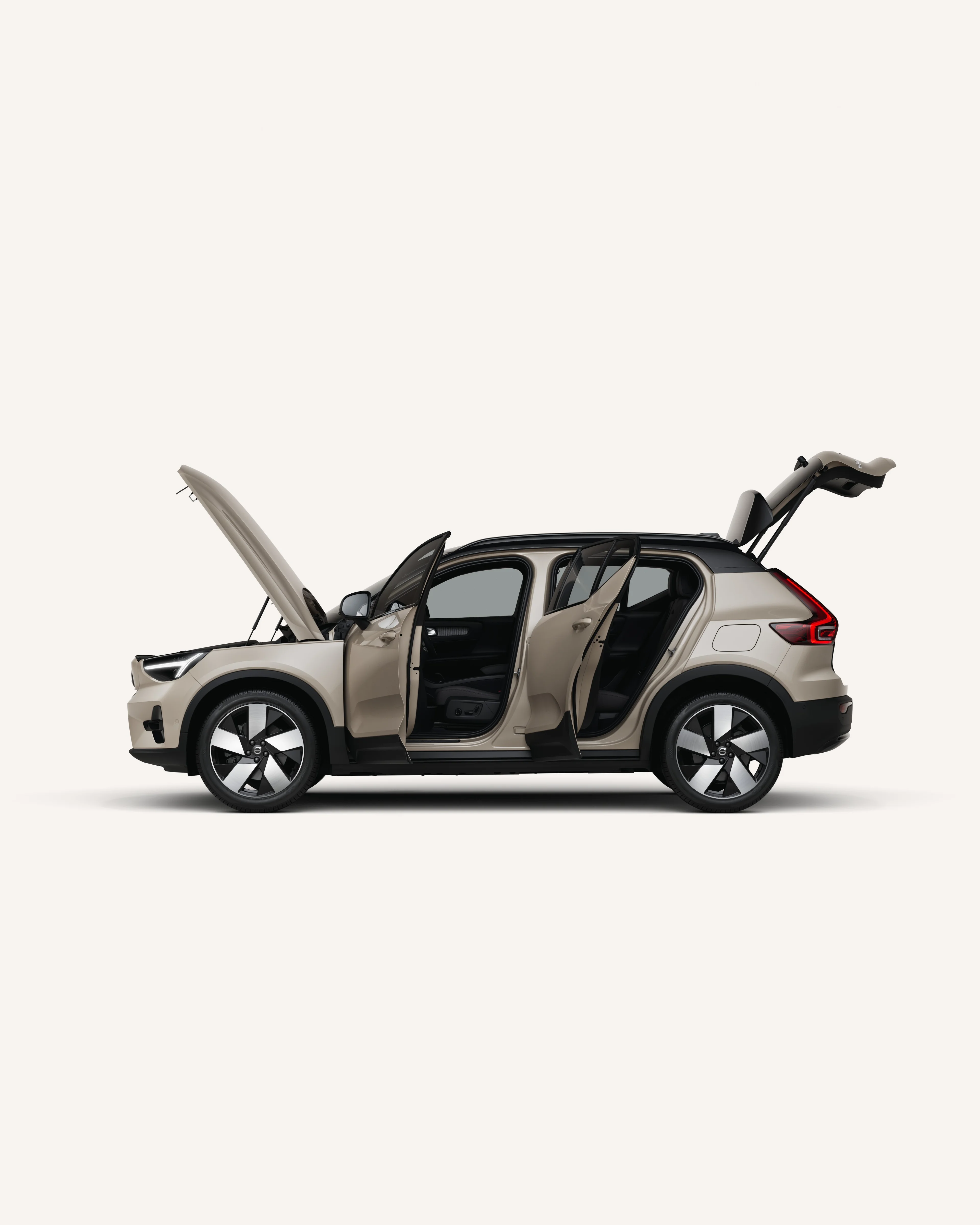 Side view of the fully electric Volvo EX40 with open hood, doors, and trunk.