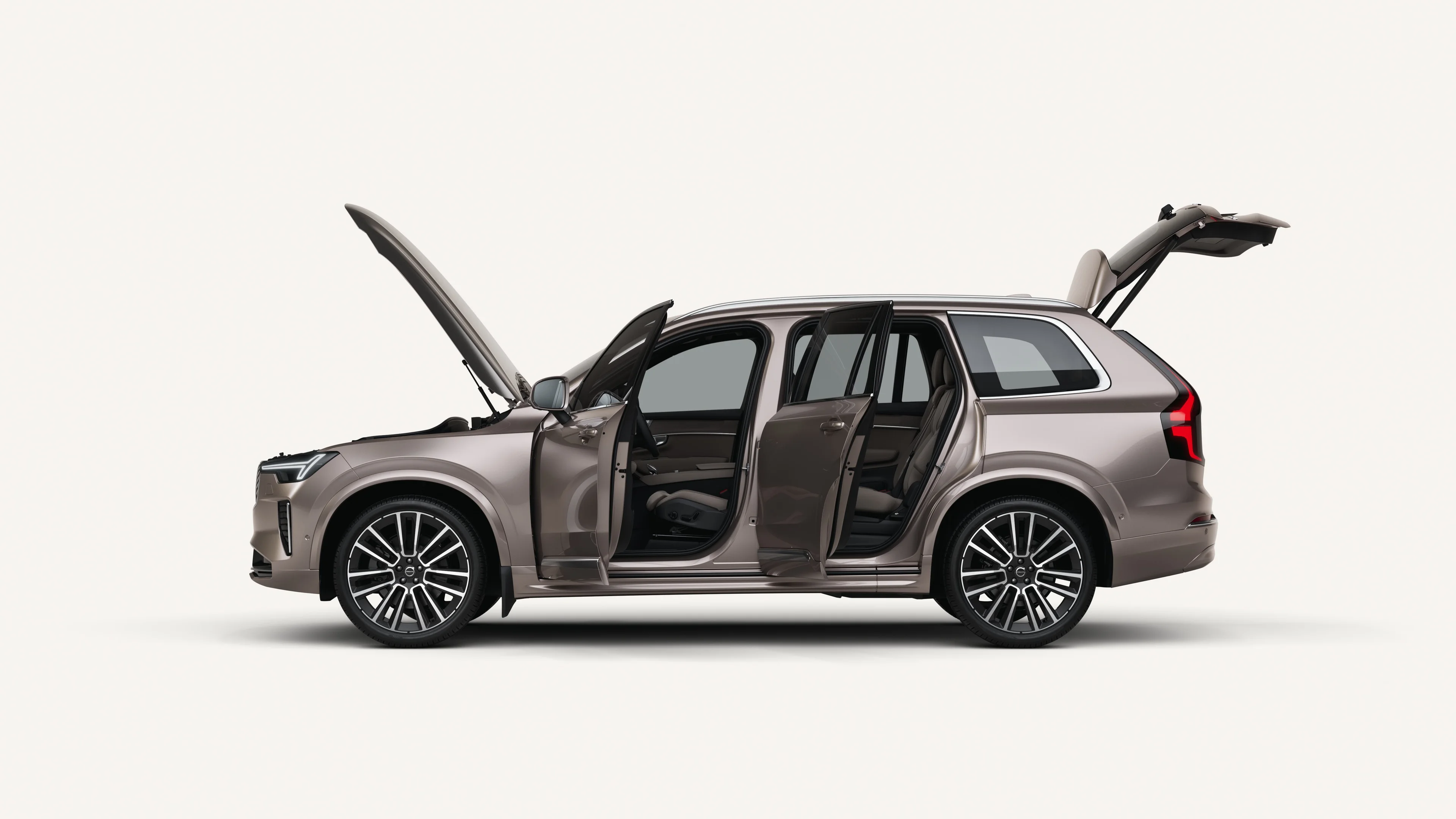 Side view of the Volvo XC90 with open hood, doors, and trunk in a white studio environment.