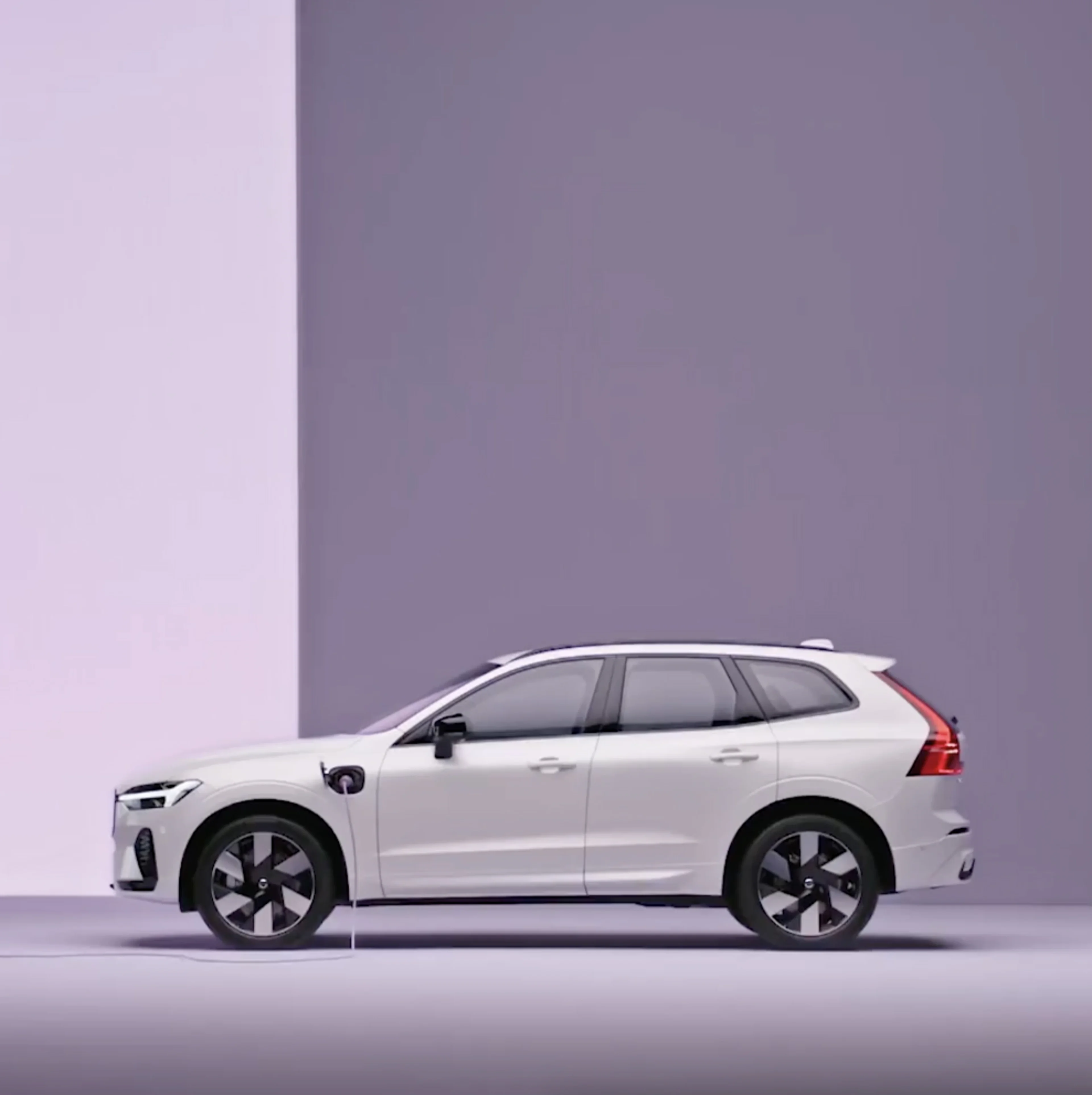 A Volvo XC60 plug-in hybrid, charging in a purple surrounding.