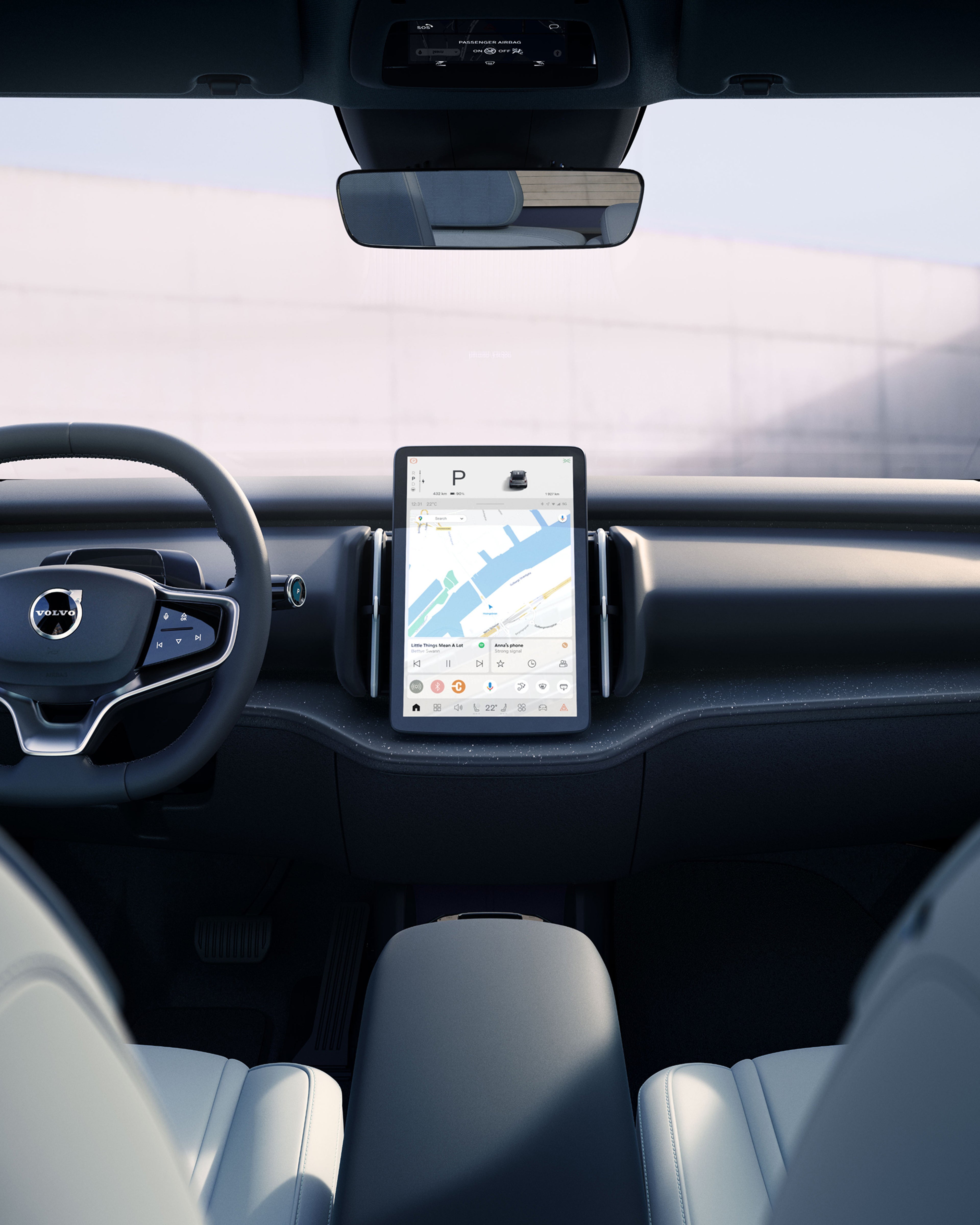 Back seat view of the EX30 dashboard, including steering wheel and touchscreen.