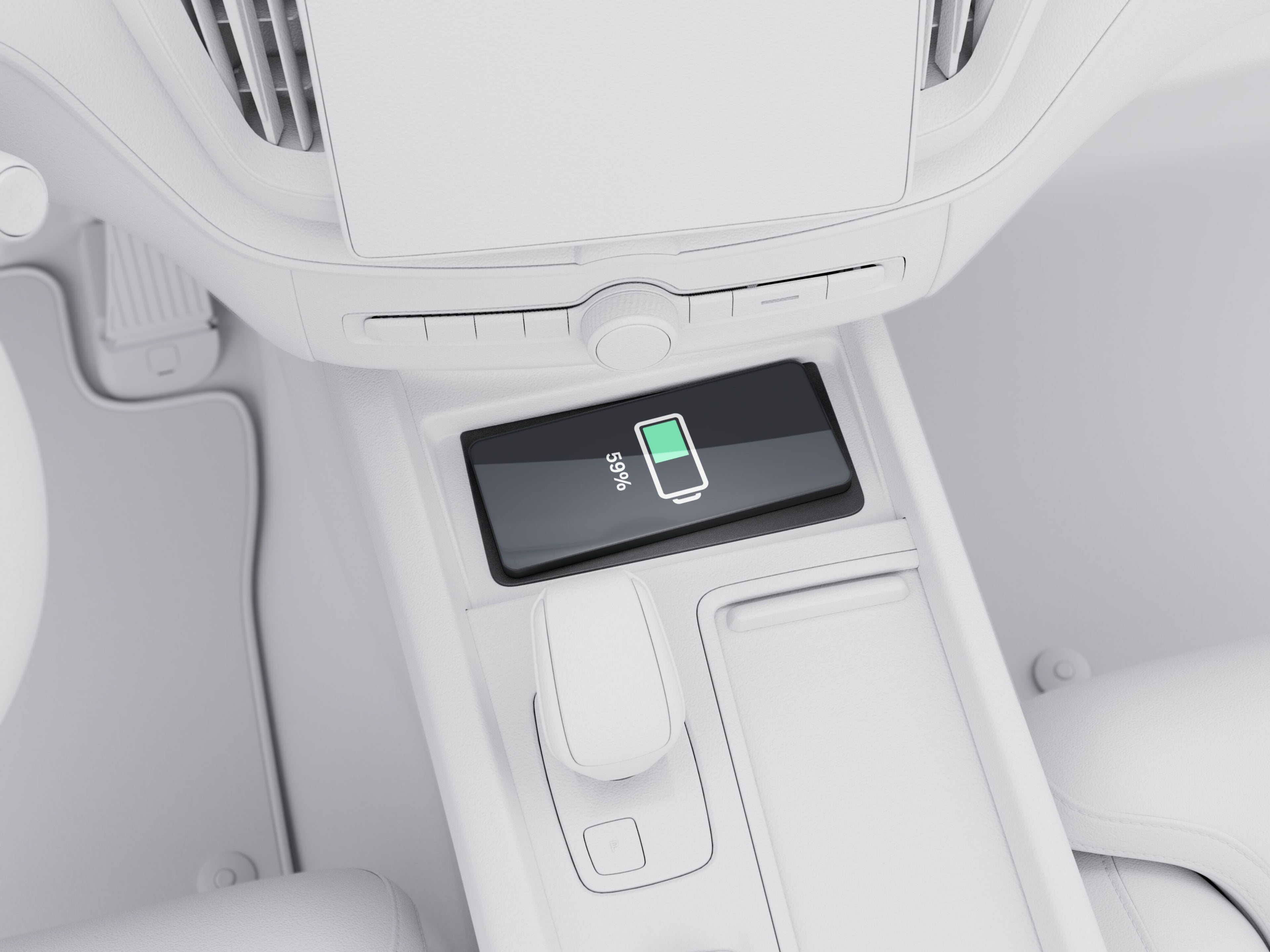 Mobile phone on the wireless charging pad in the centre console of the Volvo XC60.
