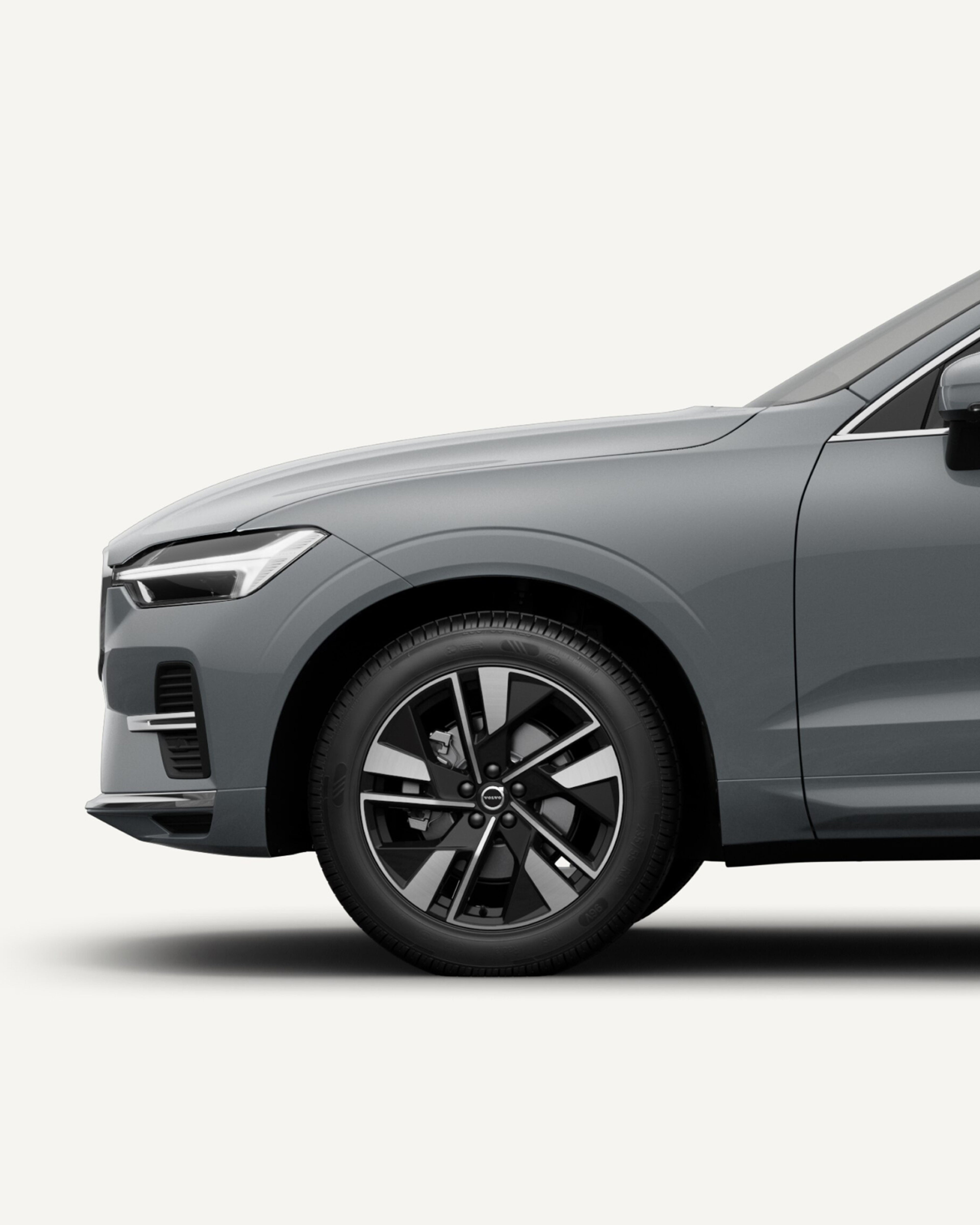 Front half of the Volvo XC60 midsize mild hybrid SUV in a white studio environment.