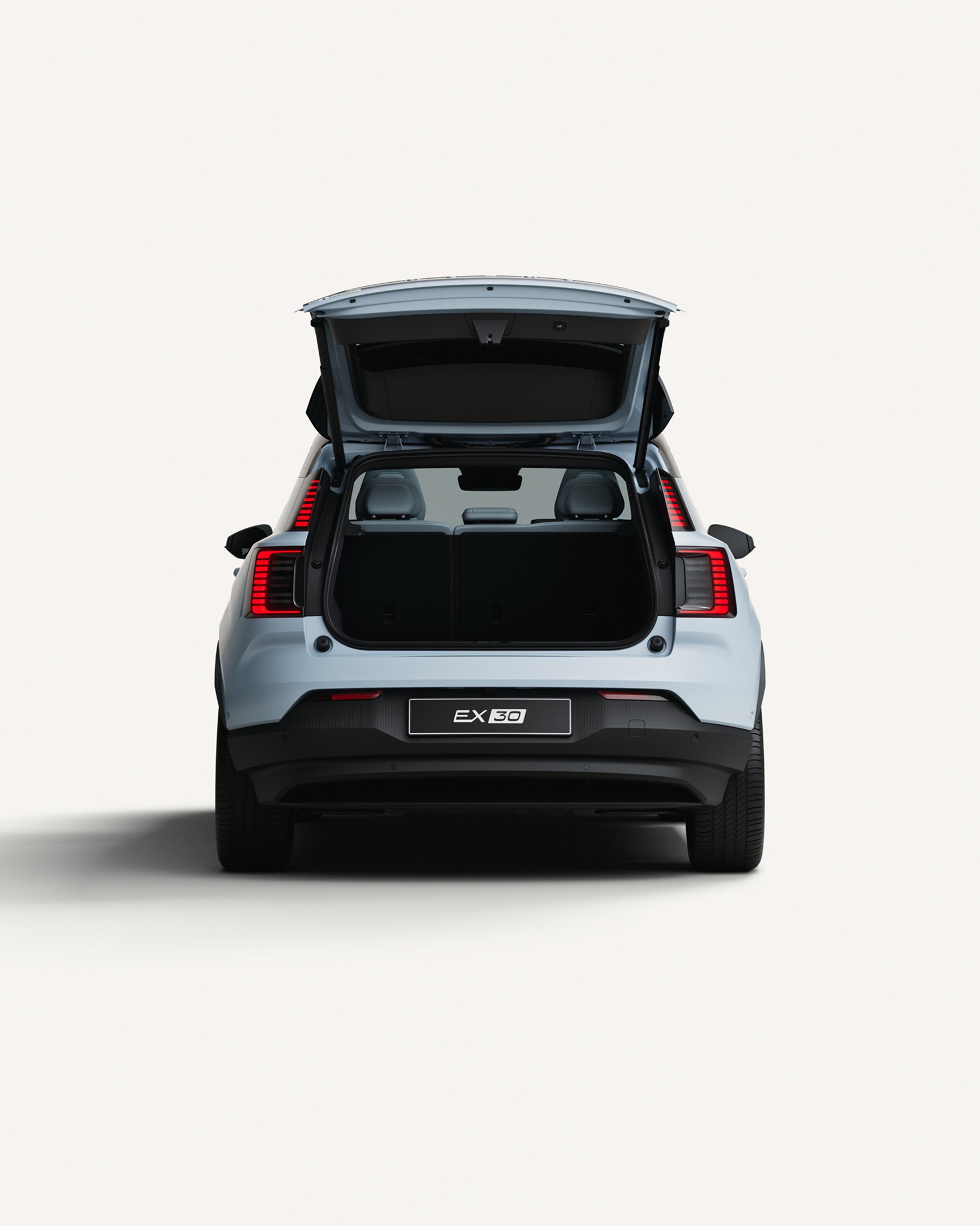 Rear view of the Volvo EX30 with the trunk open showcasing cargo area.