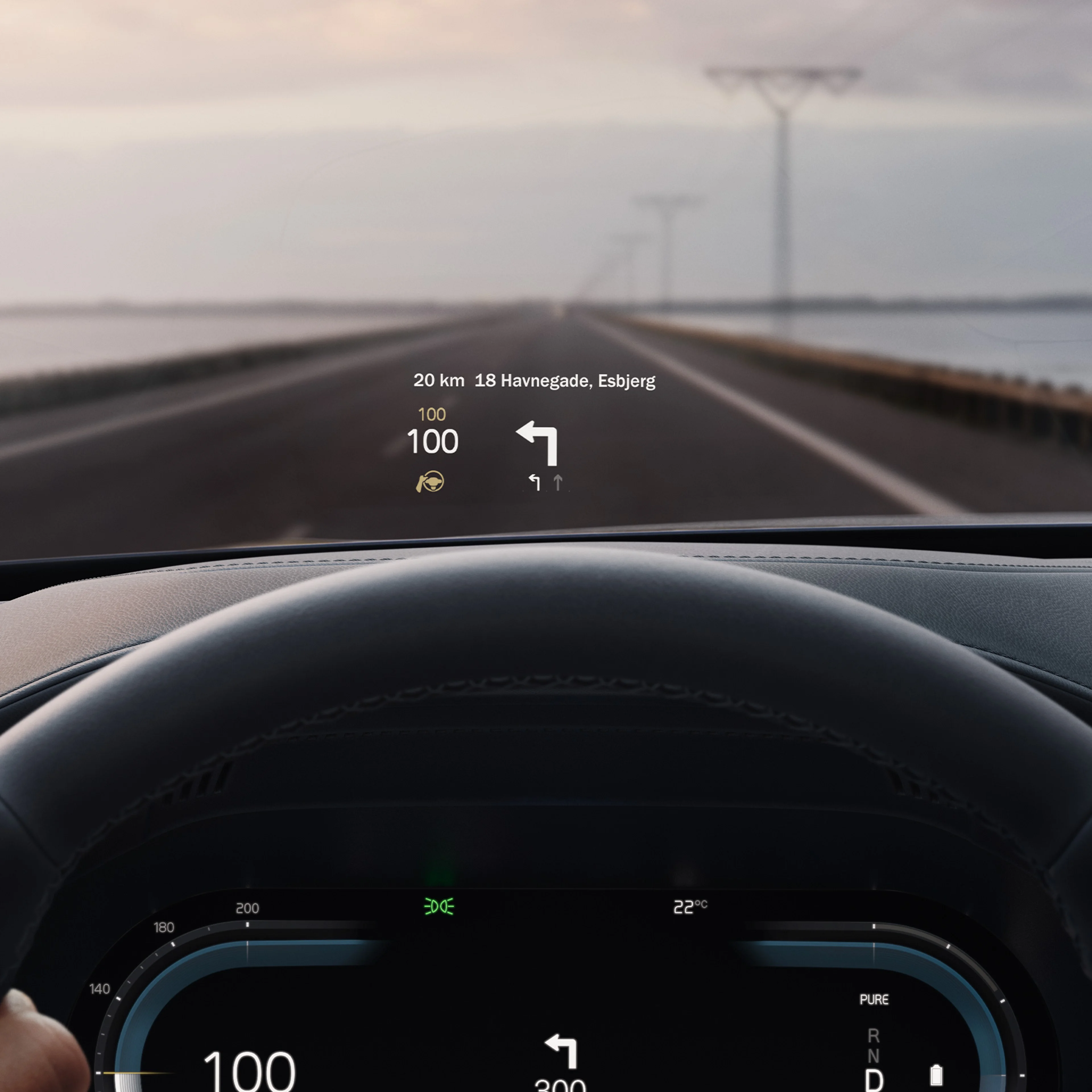 Inside a Volvo, head-up display showing driving speed and navigation on the windshield.