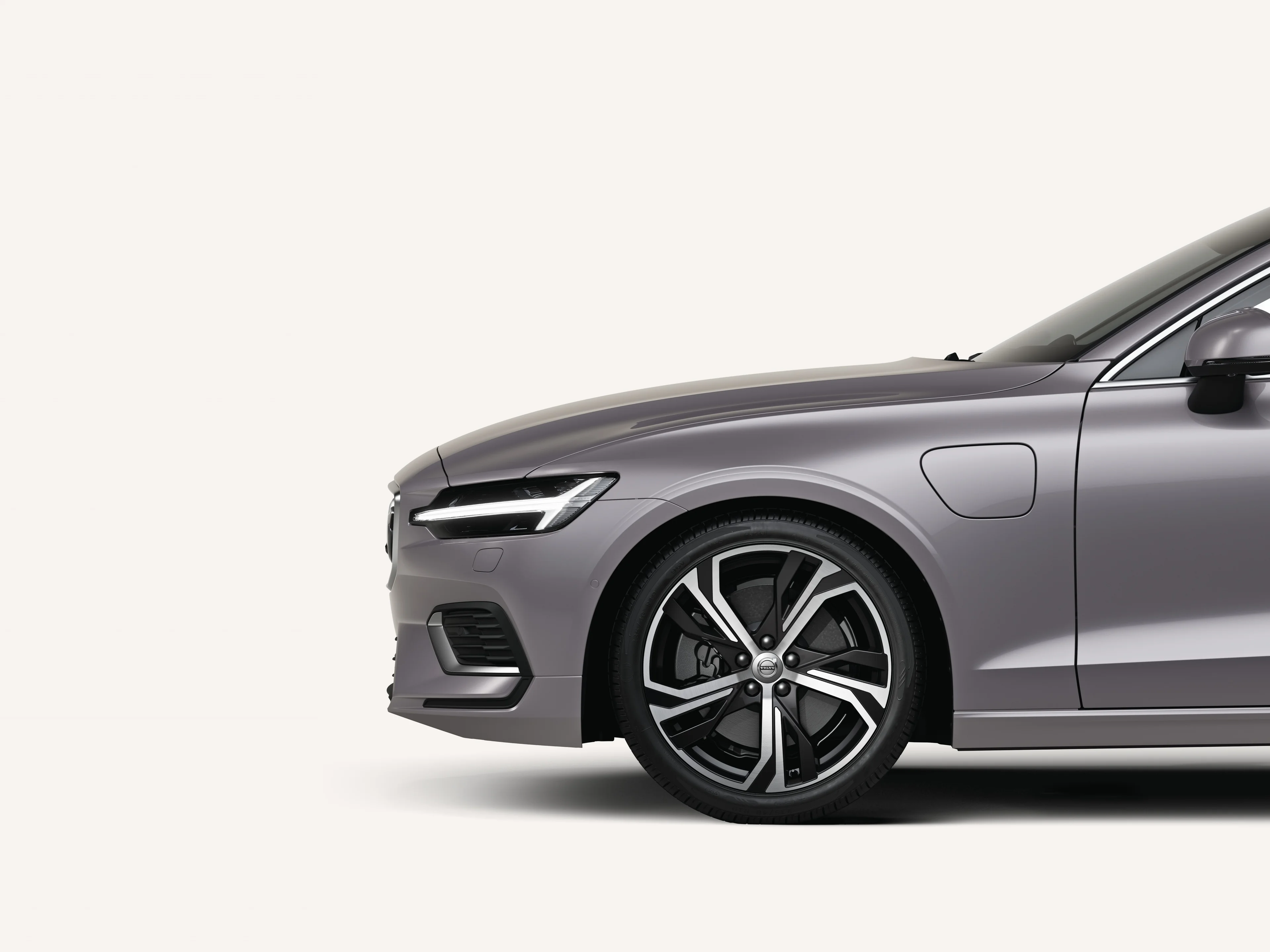 Front half of the Volvo V60 in a white studio environment.