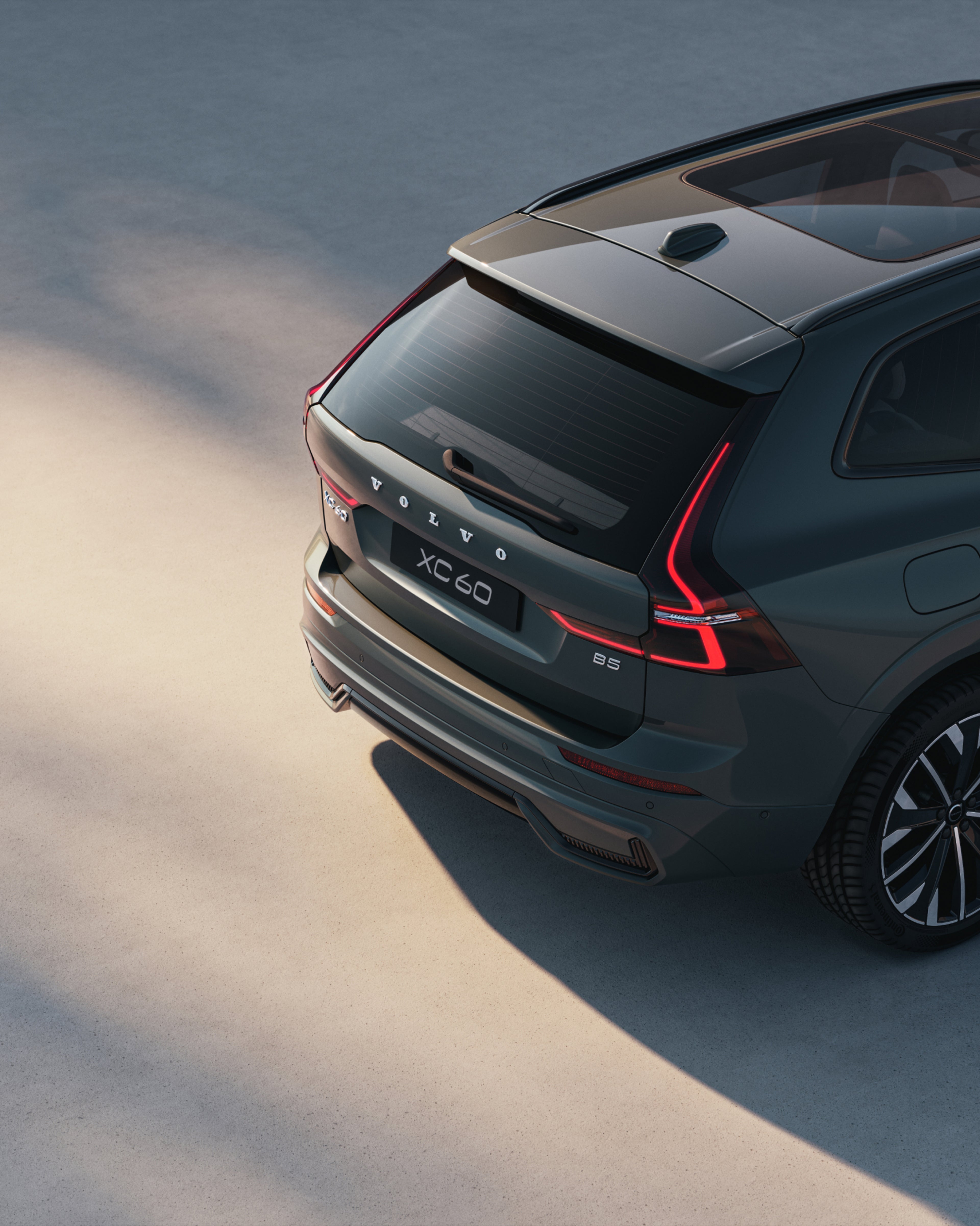 Rear-angle view of the Volvo XC60 mild hybrid SUV highlighting its LED taillights.