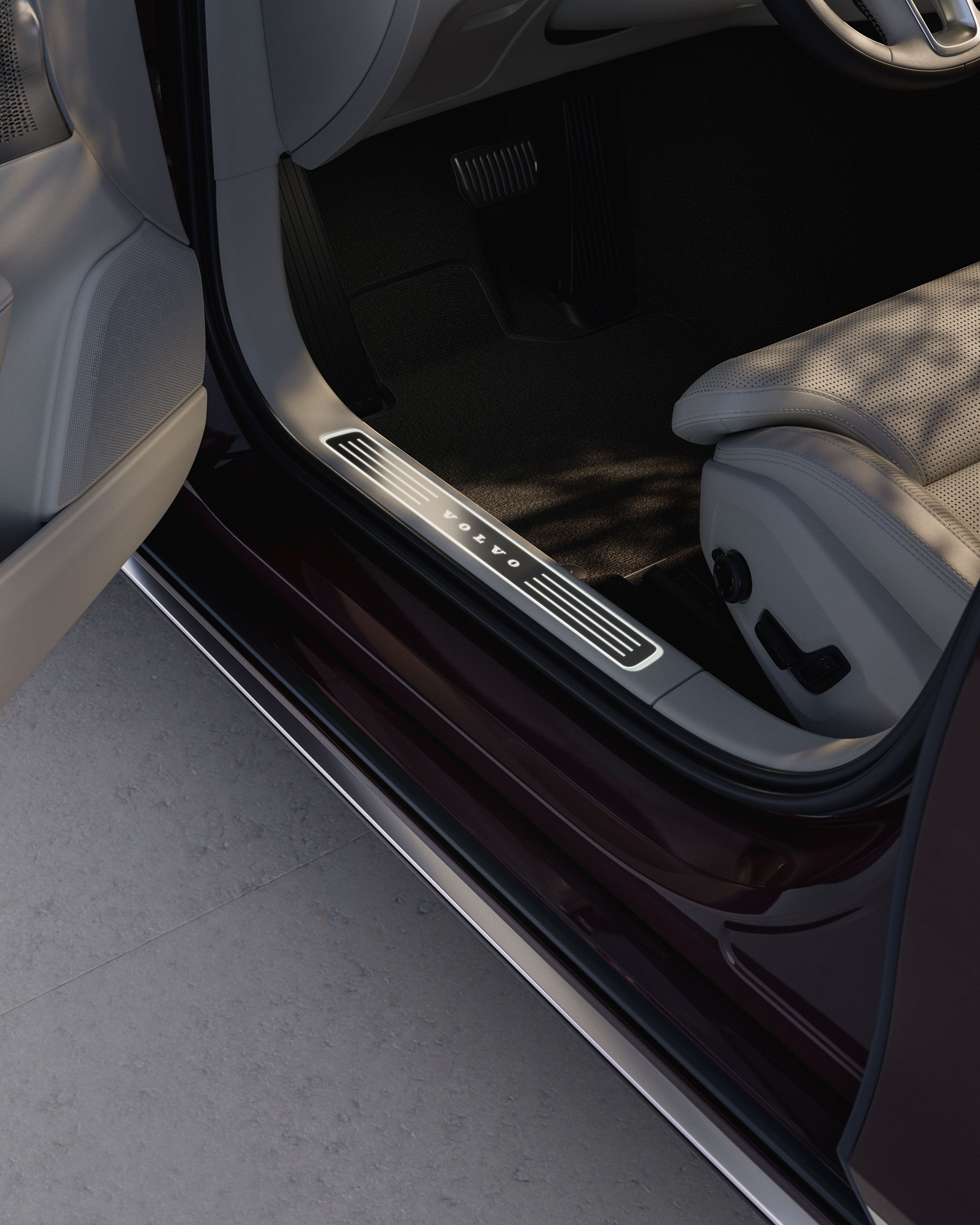 Close-up of the Volvo S90 instep plate, highlighting the illuminated Volvo Cars logotype