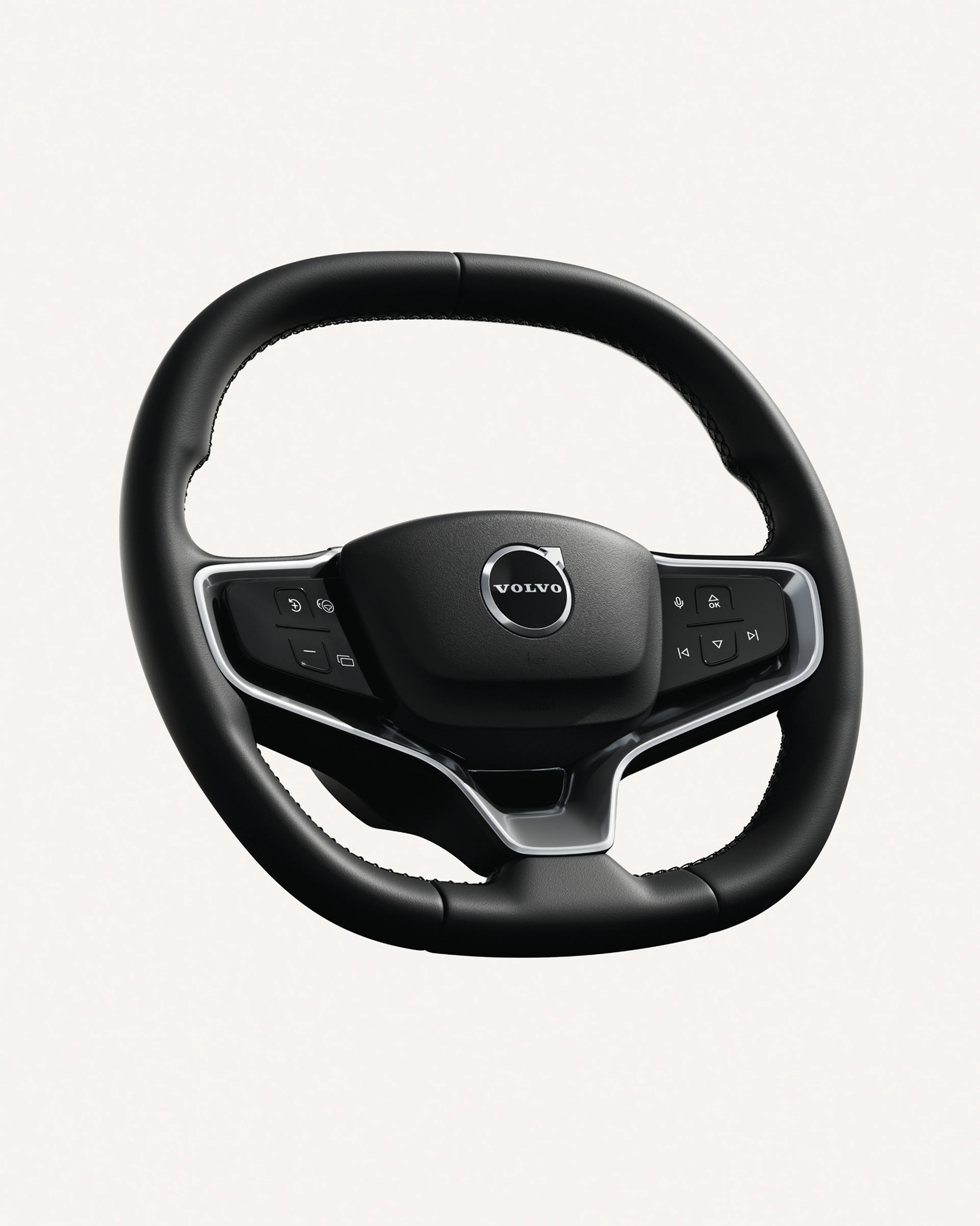Pohled zblízka na volant vozu Volvo EX30 s integrovanými ovládacími prvky.
